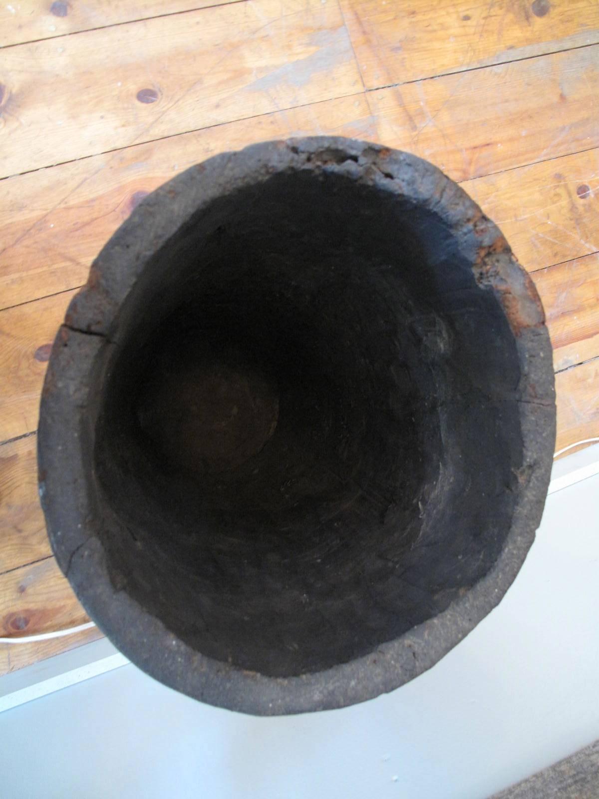 Hollowed timber cylinder, with attached plank bottom. Shows honest age and use.