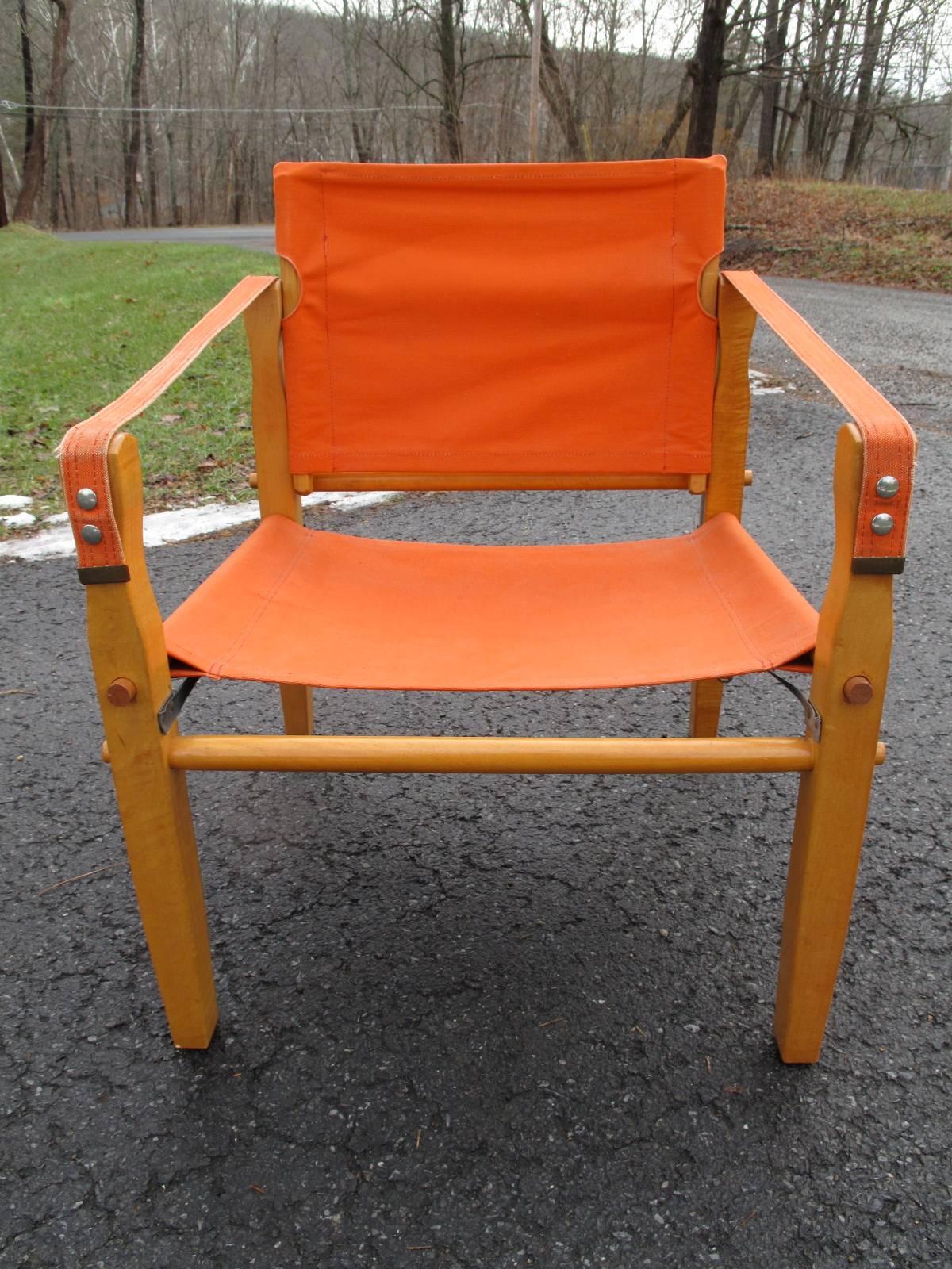 Oak pegged frame with orange canvas seat or back. Original label from Racine, Wisconsin intact as shown.