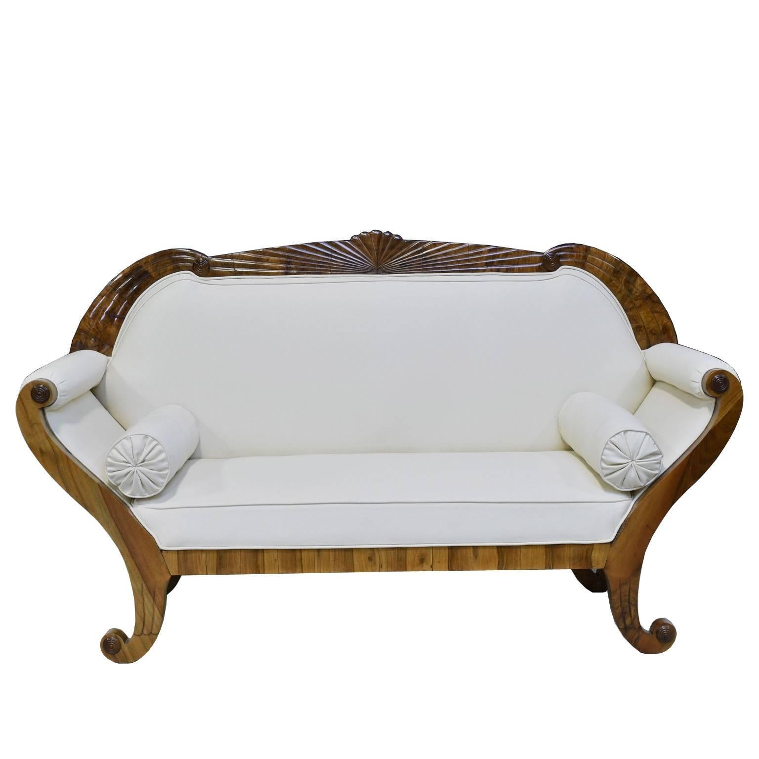 A very beautiful South German Biedermeier Sofa in fine walnut with shaped, fan-carved crest rail above scrolled armrests terminating in out-scrolled feet, Germany, circa 1830.
Note: This sofa is in very good to excellent condition and has been