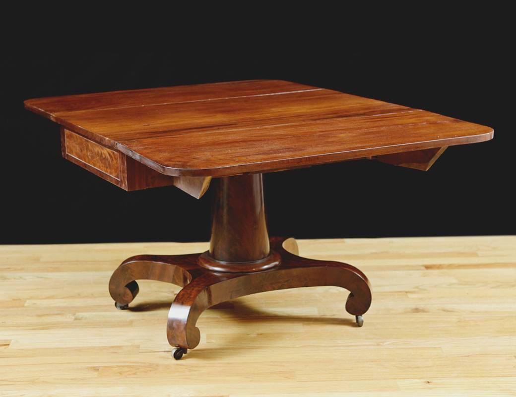 Attributable to the New York cabinetmaker, Meeks and Sons, this handsome dining table is made of premium mahogany and is inspired by the furniture designs of ancient Greece. American Greek Revival drop leaf table in mahogany, circa 1830. Probably NY