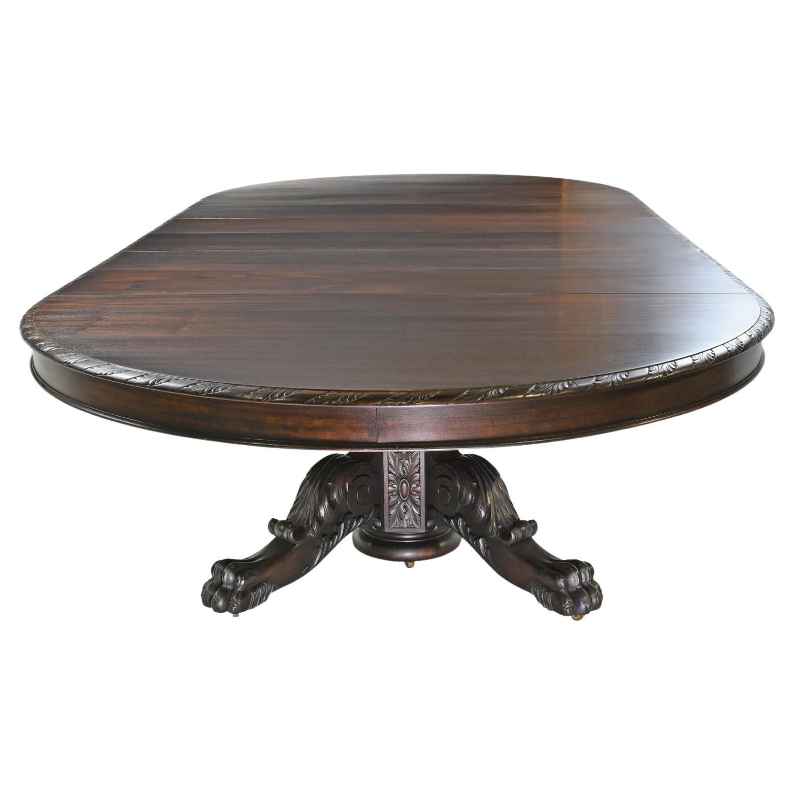 From the American Belle Époque,  referred to as the gilded age a beautiful round extension dining table that opens to a racetrack with six leaves that lengthen it from a 5 1/2 foot round to 12 foot long. Table rests on a pedestal with legs with