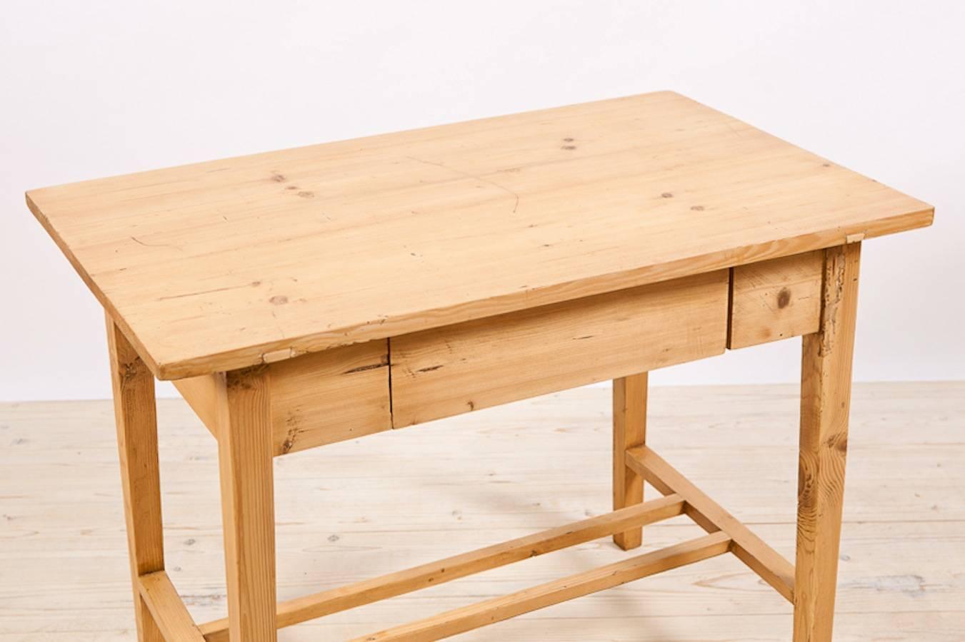 A small writing table in pine with one drawer and 