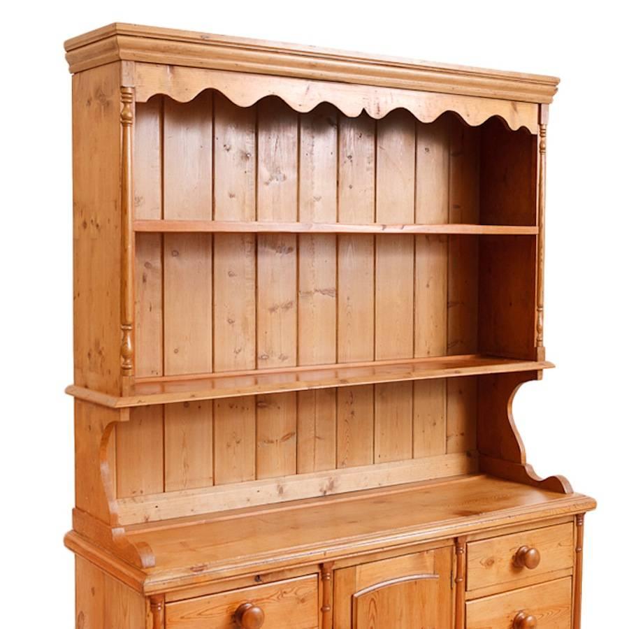 A charming Welsh dresser in scrubbed pine. Ample storage and dish rack above. 

Measures: 53 1/2" wide x 17 1/4" deep x 77 1/2" high.