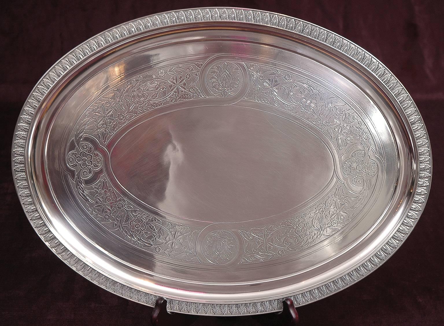 This lovely sliver plate Tiffany tray was fabricated for commercial use in 1957. Palmette design decorates border, with floral design in banding along center.

Measures: 18
