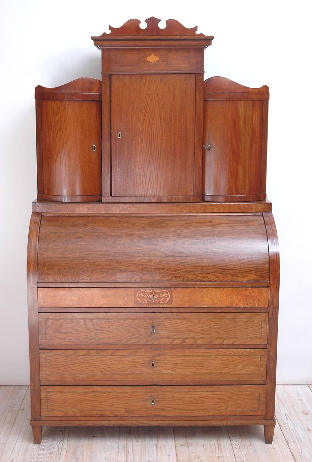 From the Hamburg/Schleswig-Holstein region of Germany, once part of Denmark, a handsome Empire secretary in ash with tiered bureau bookcase with bowed doors. Interior writing desk is in birch and kingwood and consists of ten small drawers and one