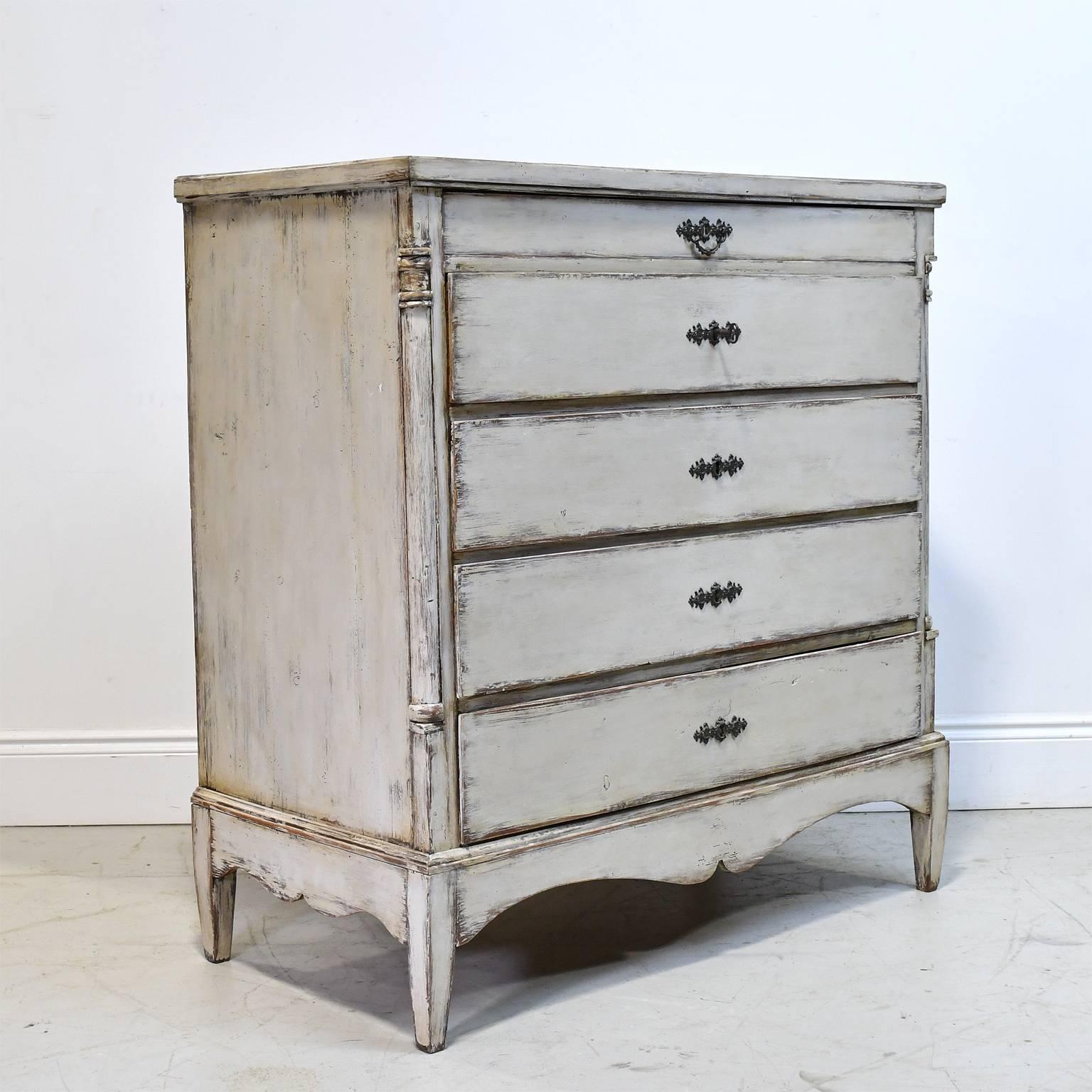 An 18th century Scandinavian chest with a painted white/grey finish consisting of five drawers which rest on a plinth base. From the Schleswig-Holstein region of Germany which was part of Denmark's Jutland peninsula during the era when this piece