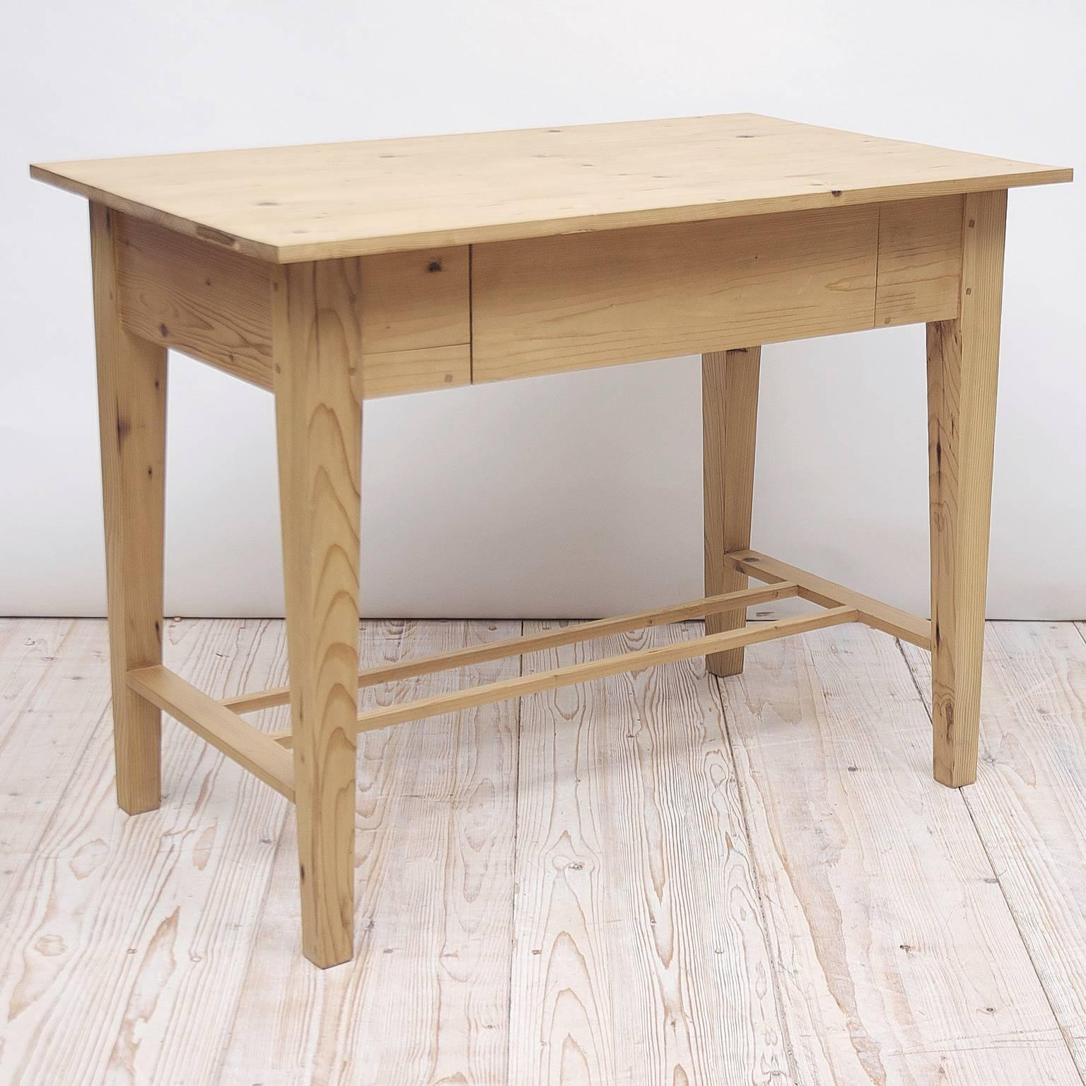 This table is a faithful reproduction of a Scandinavian Jugendstil antique writing table in our collection, circa 1900. 
Pine table with drawer fabricated from, reclaimed cheese boards originating from the Gouda factory in Holland finished with a