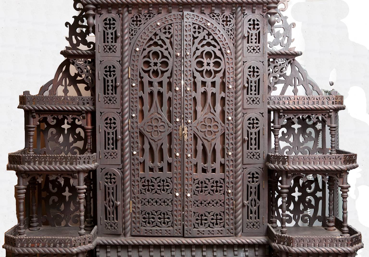 A rare and unique piece of Fretwork Folk Art from the Adirondack region with elaborate cut-out form, dressing mirrors and table, drawers, cubbies and open shelving or ètagère. New York, circa 1870-1880.


Measures: 46.5” wide x 16” deep x 74.5”