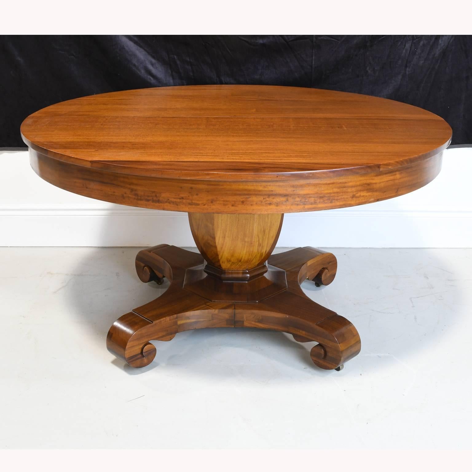 A center pedestal or dining table in mahogany in the Grecian form with round top resting on faceted urn pillar and ending on quatre-form base, American, circa 1880. 

54