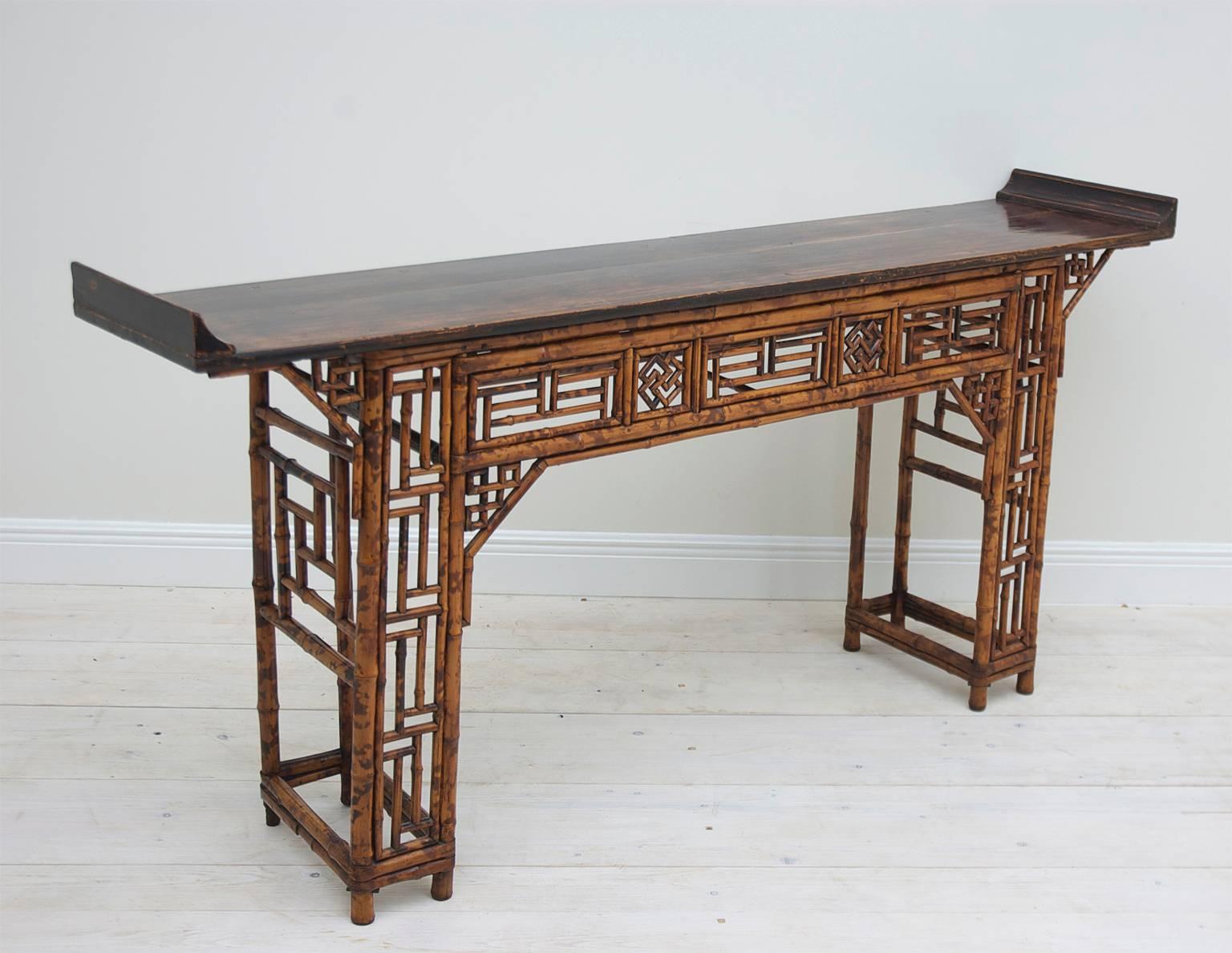 A very beautiful bamboo altar table with everted ends on elm top with on recessed double-pedestal base with open lattice work. Qing dynasty, China, circa early-mid 1800s.

The narrow depth makes this a wonderful entrance table, sideboard or sofa
