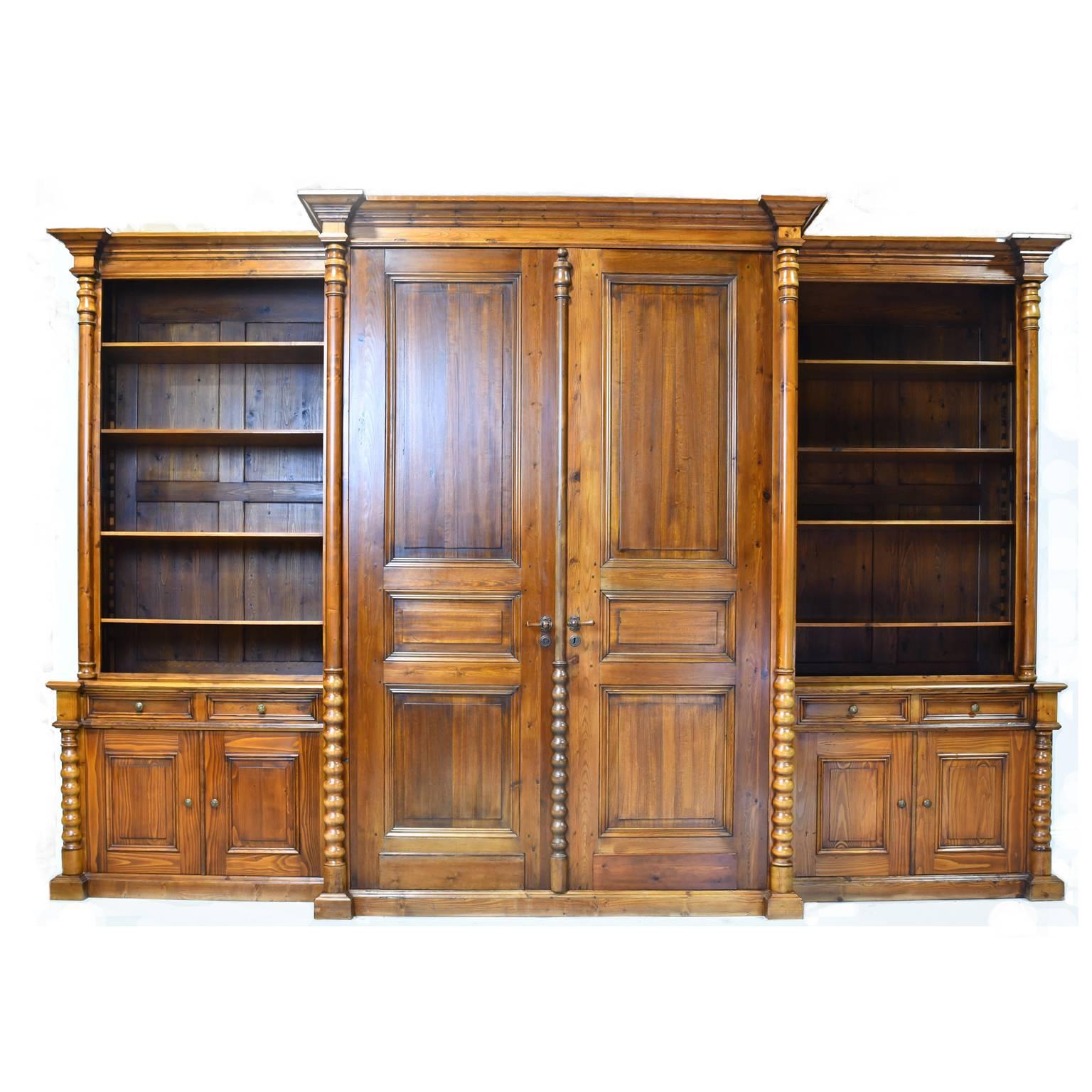 This handsome and massive wall unit was designed & built in our workshop 15 years ago using antique doors and other elements, along with pine that was re-purposed from old Dutch Gouda cheese boards. The antique center doors are retractable, and