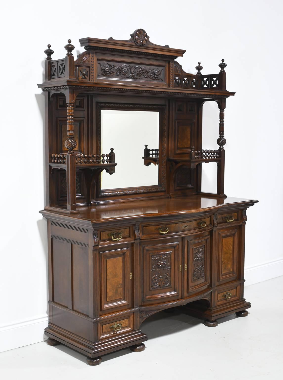 From the American Golden Age, a very fine Belle Époque Sideboard or Buffet Cabinet in exquisite West Indies mahogany. New York City, circa 1880. Base features bowed center cabinet doors with finely carved panels, flanked by a cabinet door on each