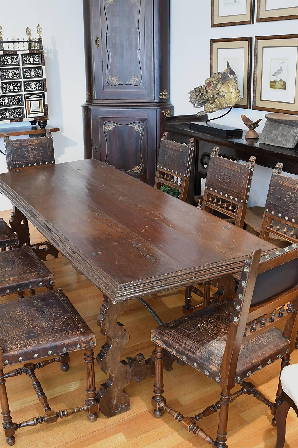 A beautiful 18th century Spanish baroque guard room /dining table in walnut with plank-top resting on carved H-form trestle legs and hand-forged iron stretchers forged in Toledo. Spain, circa mid 1700s.
A great table under a large contemporary