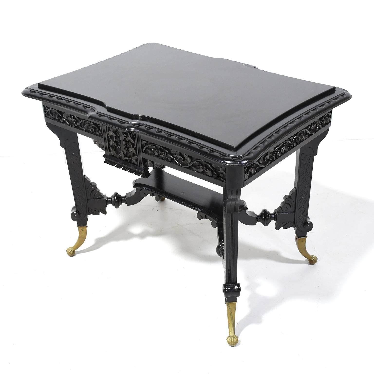 American Aesthetic Movement Centre Table in Carved Ebonized Wood with Brass Feet, c. 1870