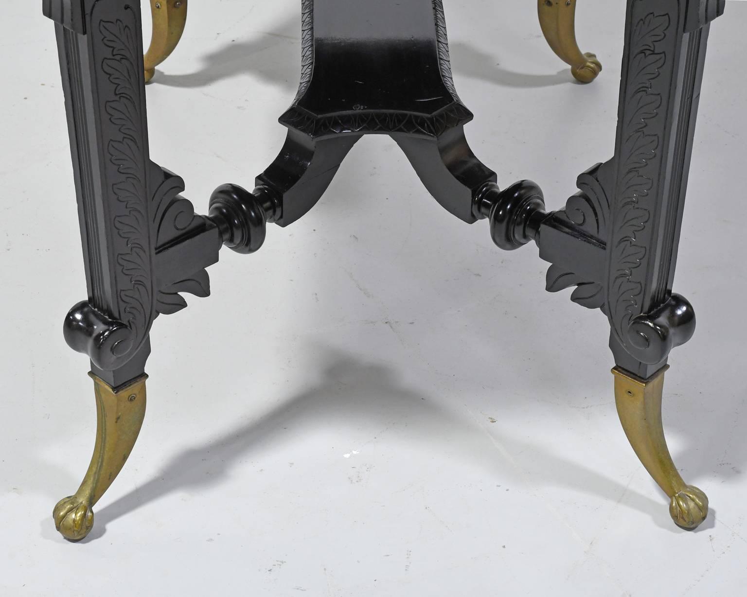 Aesthetic Movement Centre Table in Carved Ebonized Wood with Brass Feet, c. 1870 1