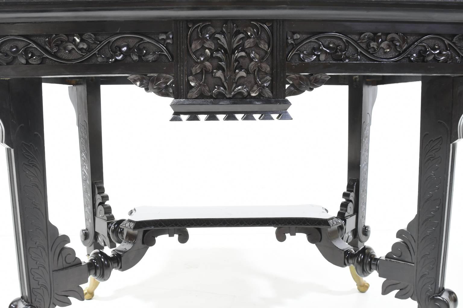 Aesthetic Movement Centre Table in Carved Ebonized Wood with Brass Feet, c. 1870 3