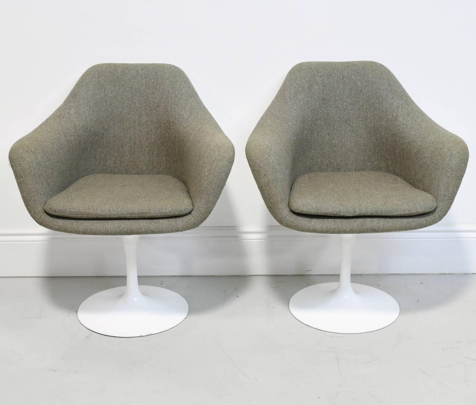 Pair of vintage knoll Eero Saarinen tulip chairs in good condition with original knoll fabric. The fully upholstered tulip armchair features an upholstered inner shell. Upholstered foam cushions are removable, with a zippered cover and Velcro