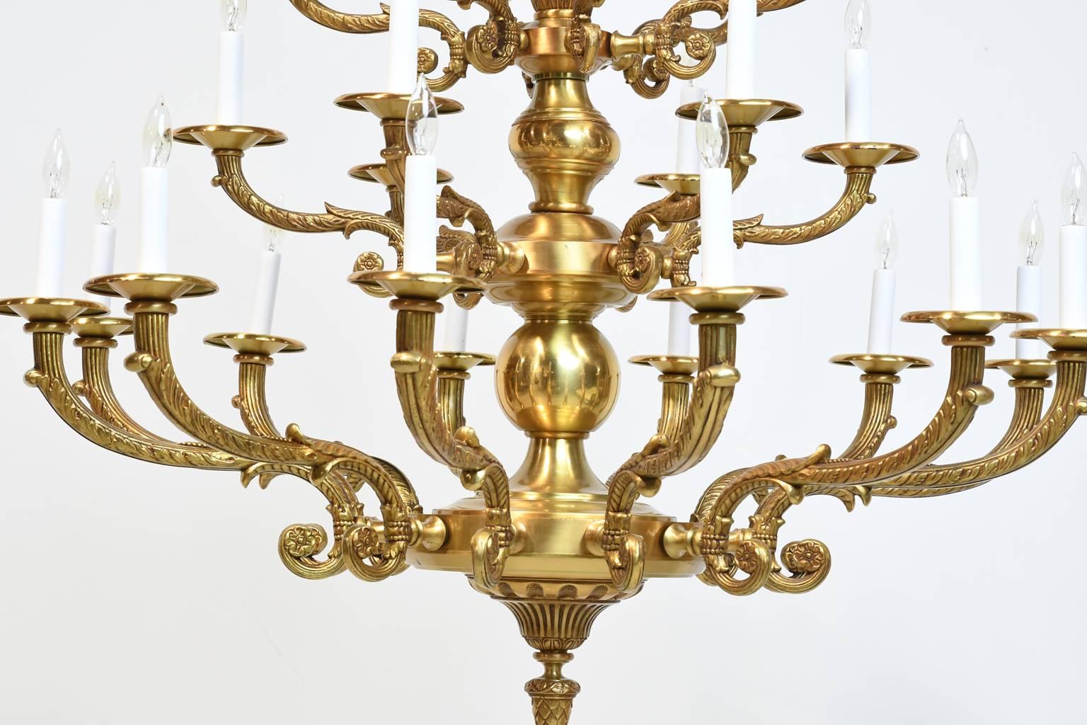 A very large and handsome brass chandelier with three staggered tiers offering 25 lights that can illuminate a total of 1,000 watts, using 15 to 40 watt bulbs per light. Re-wired with a heavy gauge wire to allow for 1,000 watts. All electrical parts