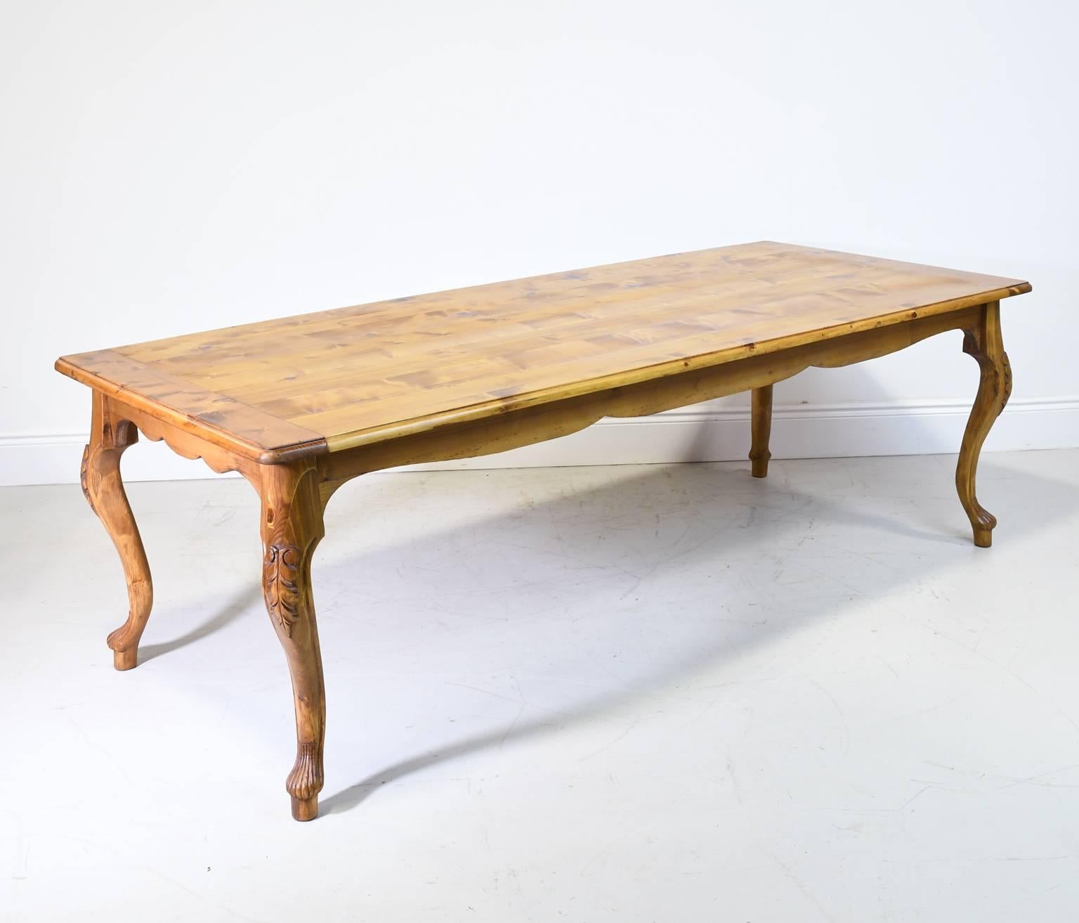 A pine farmhouse dining table in the French Provincial style with cabriole legs with carved acanthus leaf motif on the knees, and undulating apron. Hand-rubbed oil finish. Beautifully designed & solidly built in the Netherlands, circa