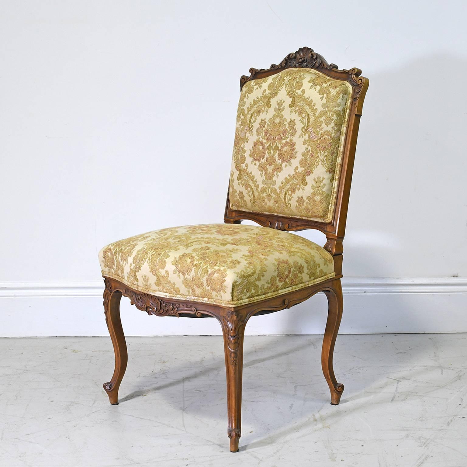 A very lovely and comfortable pair of 19th century Louis XV style dining or salon chairs in the Rococo style with carved walnut frames, cabriole legs, escargot feet and upholstered seat and back, France, circa 1860.
A decorative addition to a