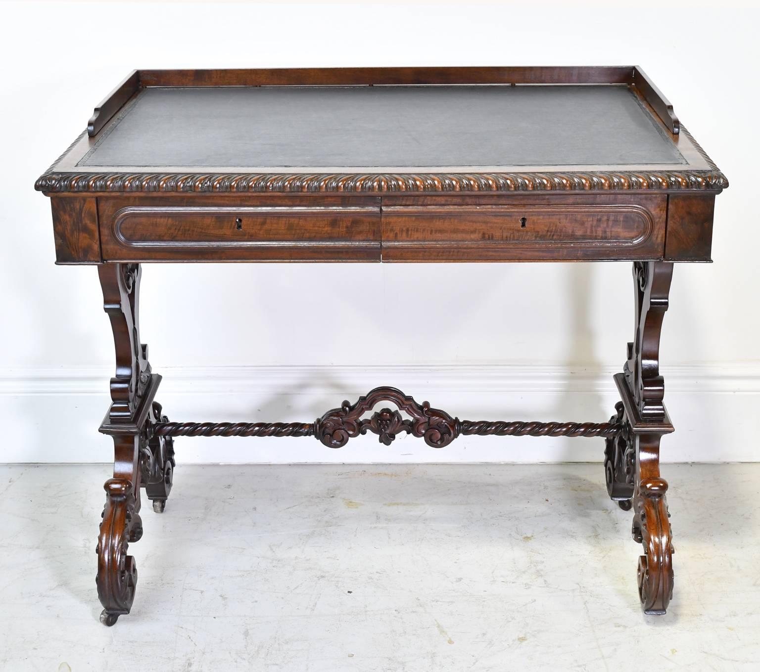 A very handsome American Rococo Revival writing table in fine plum mahogany attributable to well-known New York City cabinet maker, Joseph Meeks & Sons. Features inset leather top with tooled border, well-articulated gadrooning along table edge, two