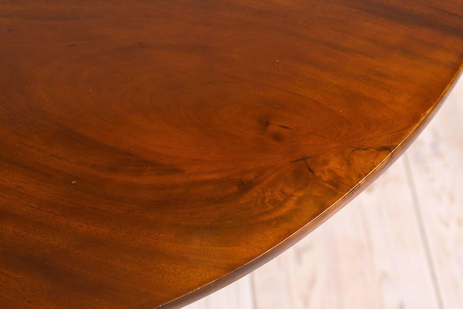 A very lovely tea table with round tilt-top on urn-turned center column resting on tripod 