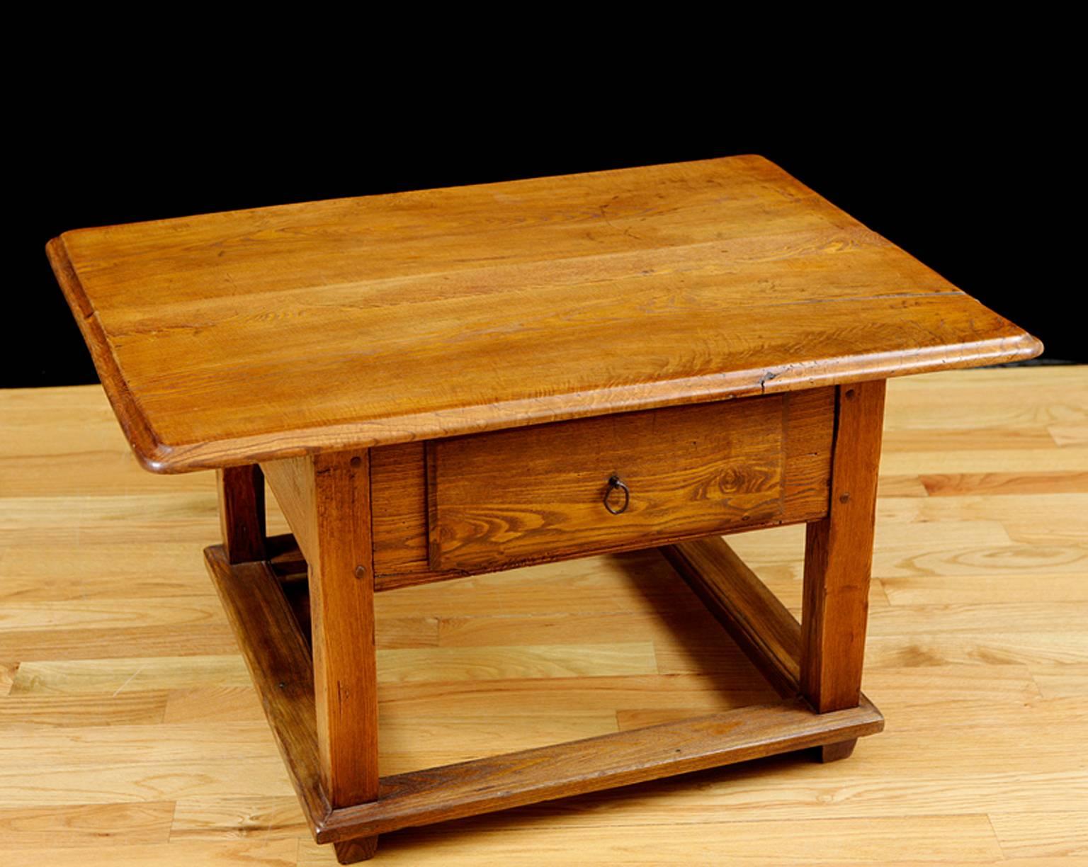 From the Tyrol region in the Austrian Alps, a charming Baroque table, rich with the patina of age, in ash with box stretcher and one drawer. Table was shortened for use as a coffee table. Austria, circa mid-1700s. 
Measures: 41