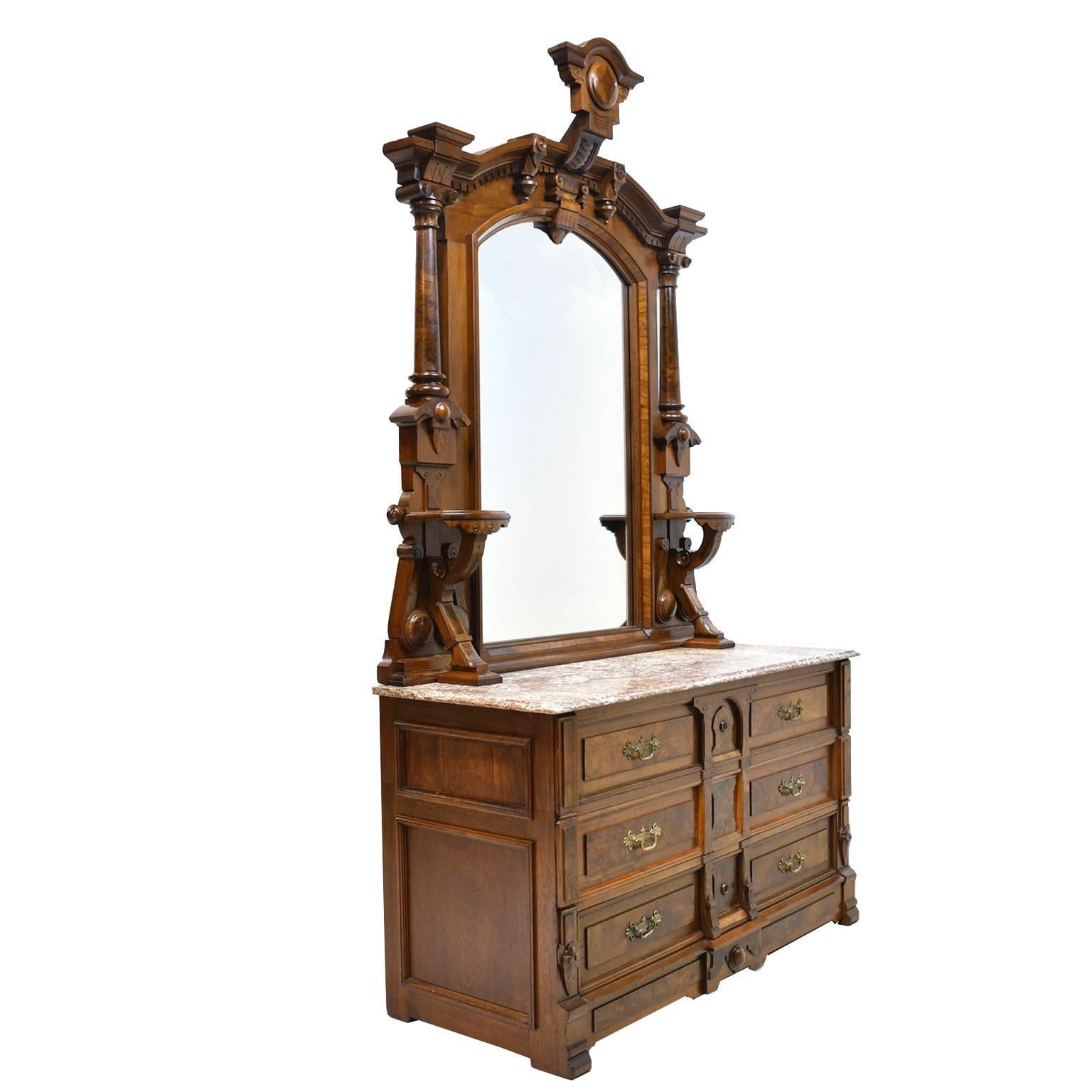Perfect cabinet to drop in a sink for a bathroom vanity. A stunning monumental chest of drawers in walnut with mirror resting on original reddish brown & white marble top, with raised decorative panels in figured & burl walnut. Shows expert