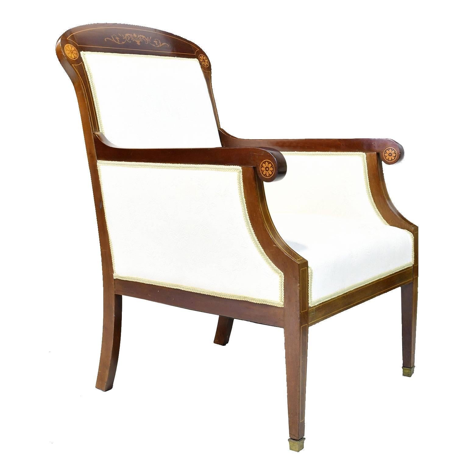 A very fine pair of bergères in beautiful West Indies mahogany with upholstery. Frame has fine inlays in satinwood of pinwheels on the scrolled arms and corners of the rounded crest flanking the center swag with foliate inlays. Chairs rest on