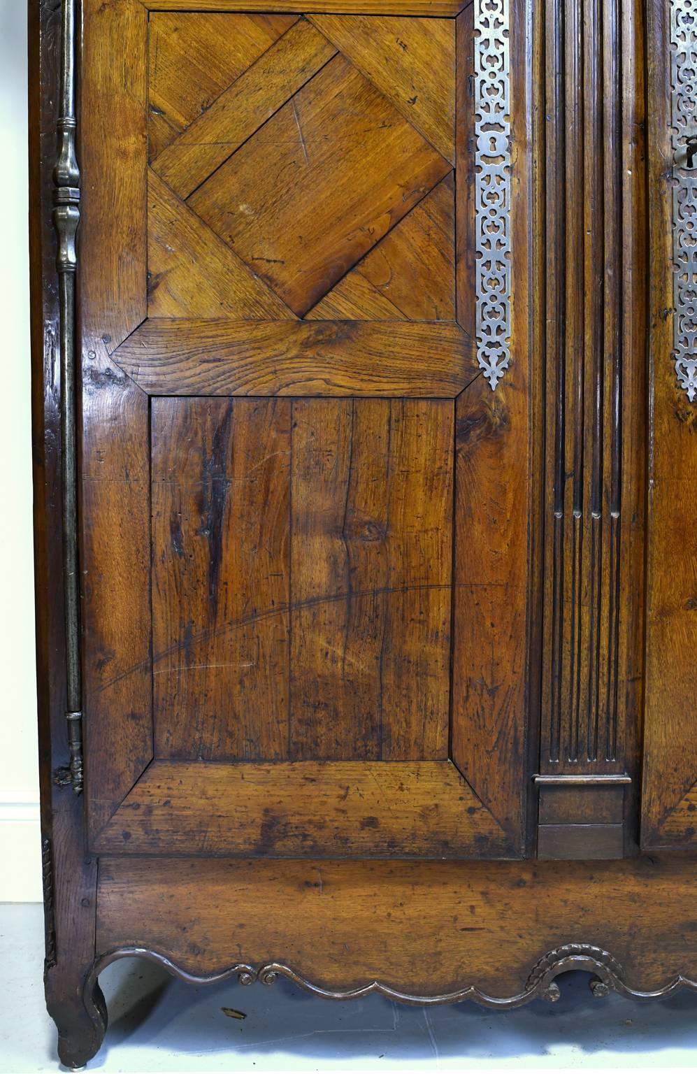 Cast 18th Century Country French Armoire in Walnut with Arched Bonnet For Sale