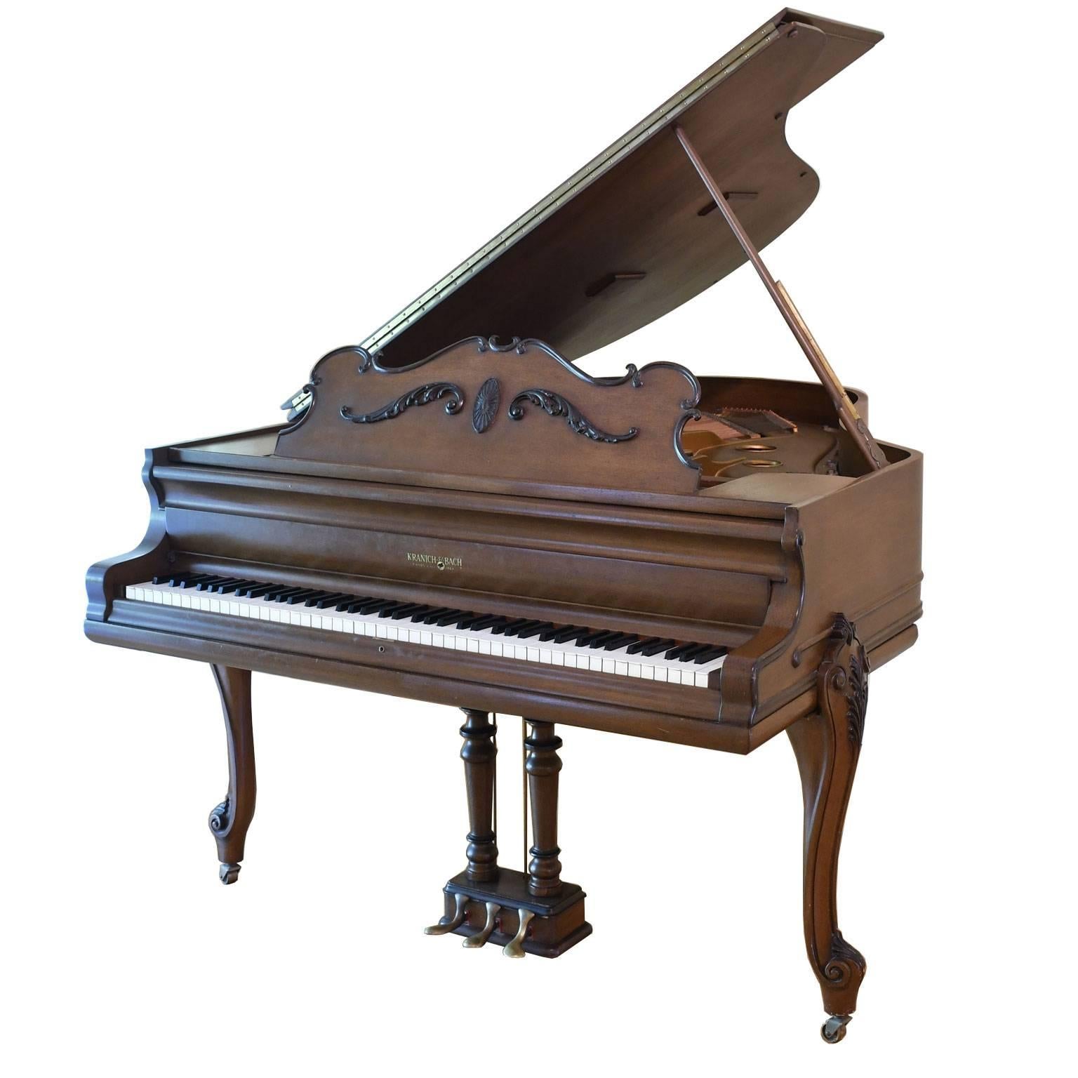 Most likely made in the Rochester, New York, factory in 1903, this fine petite baby grand piano is in excellent playing condition. The case is in the French Louis XV style with carved cabriole legs and is in a medium-colored semi-gloss walnut. There