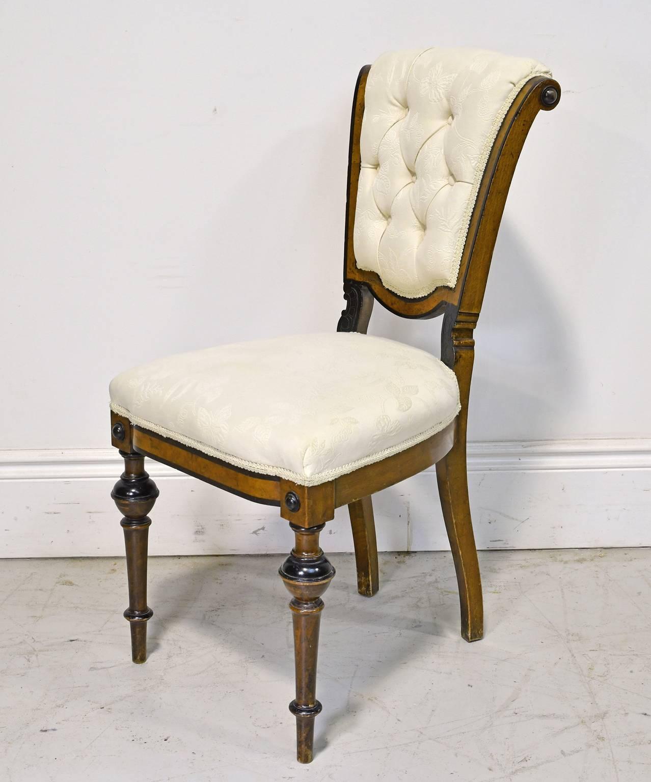 A very sculptural-looking chair with tufted, scroll-back & upholstered seat, and resting on turned front legs. In walnut with ebonized details that highlight the beautiful silhouette of the chair.  Denmark, circa 1870.
Note: Very comfortable!