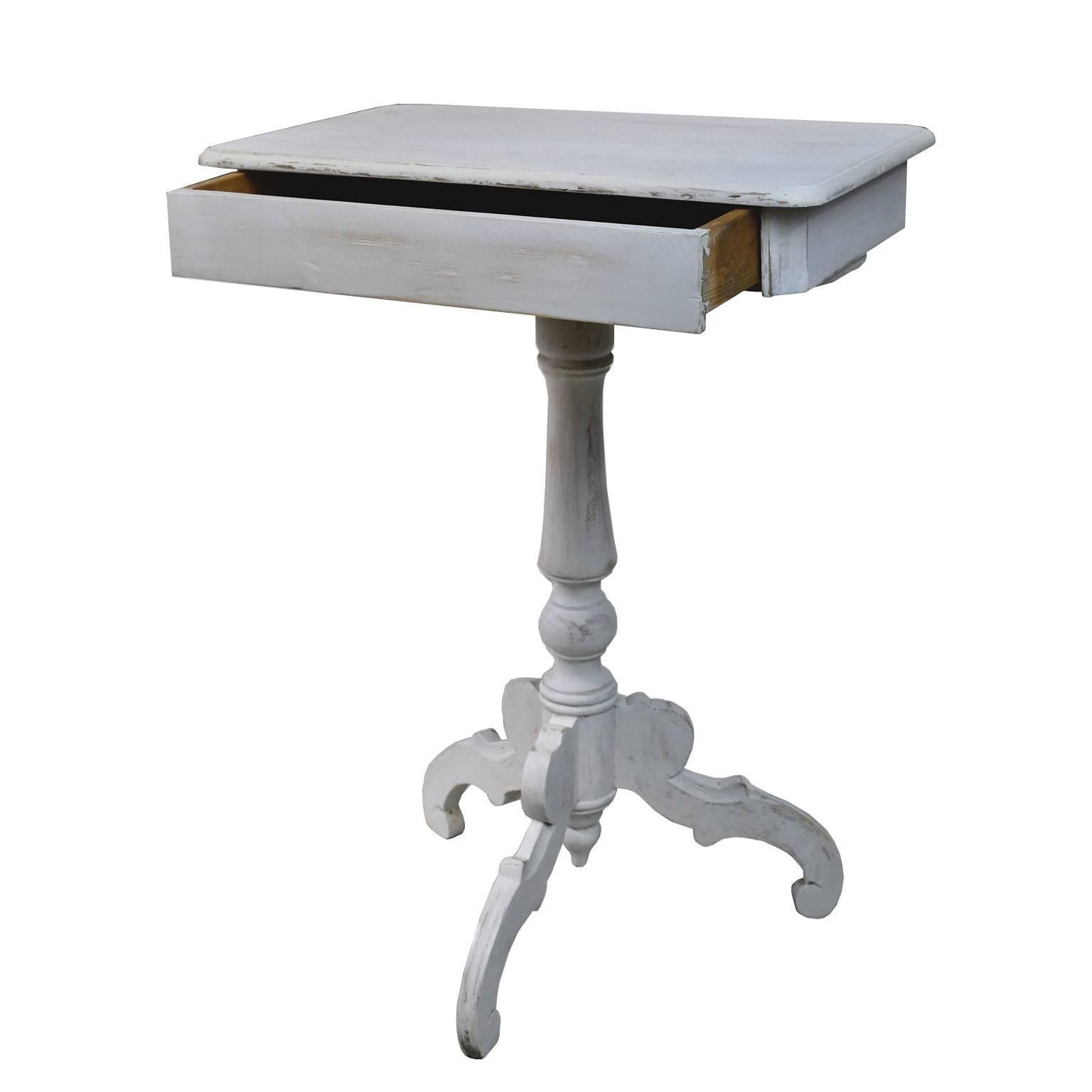 A charming & small Gustavian end table with rectangular top on tri-foot pedestal base, offering one drawer. Beautifully-restored by us, this Swedish table is painted a lovely shade of pale grey/white over the original pine, Sweden, circa