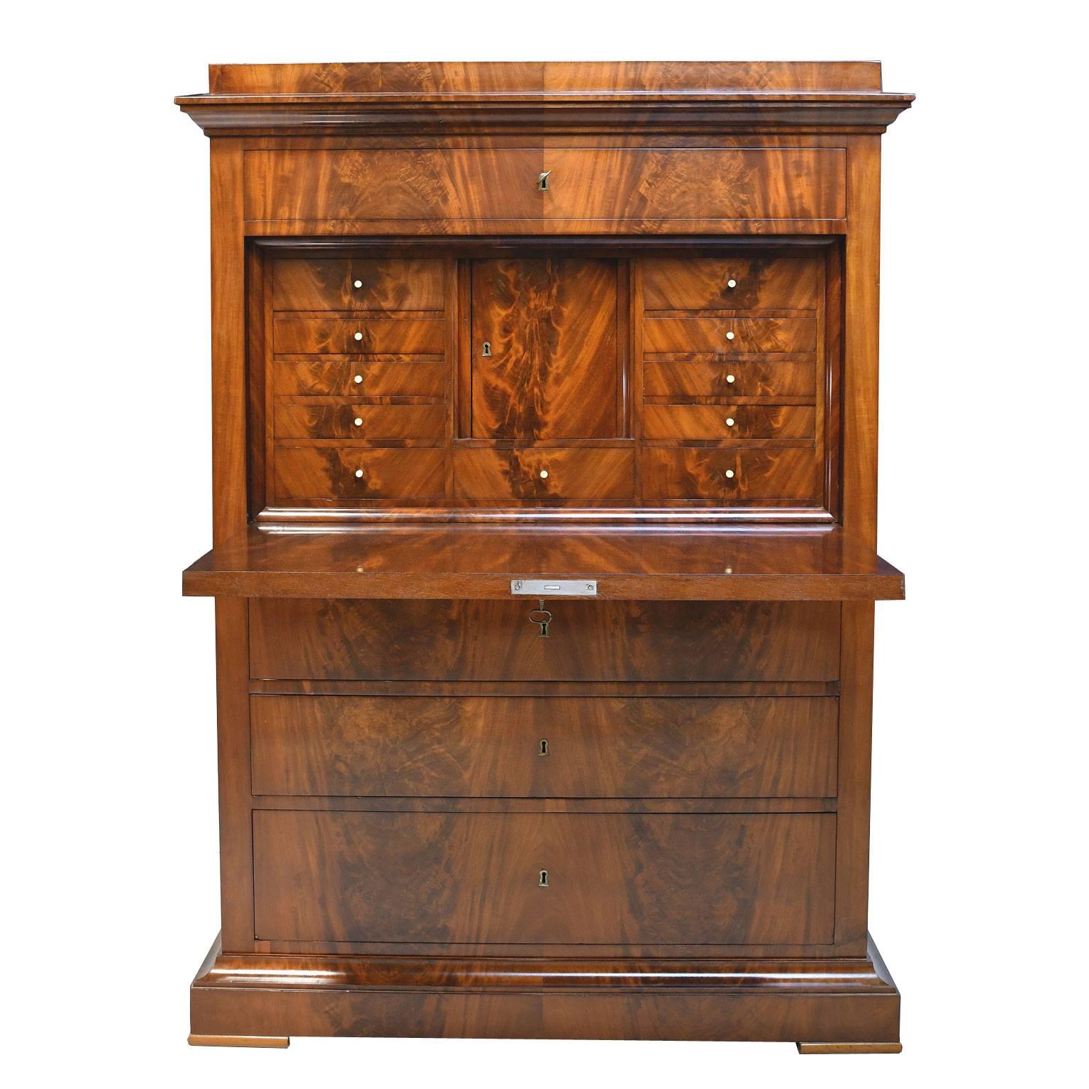 An exquisite Biedermeier secretary in very fine Cuban/ West Indies mahogany with all of the original appointments which include the hardware, pulls and keys. The cabinet's joinery, along with the quality of the book-matching of the crotch mahogany