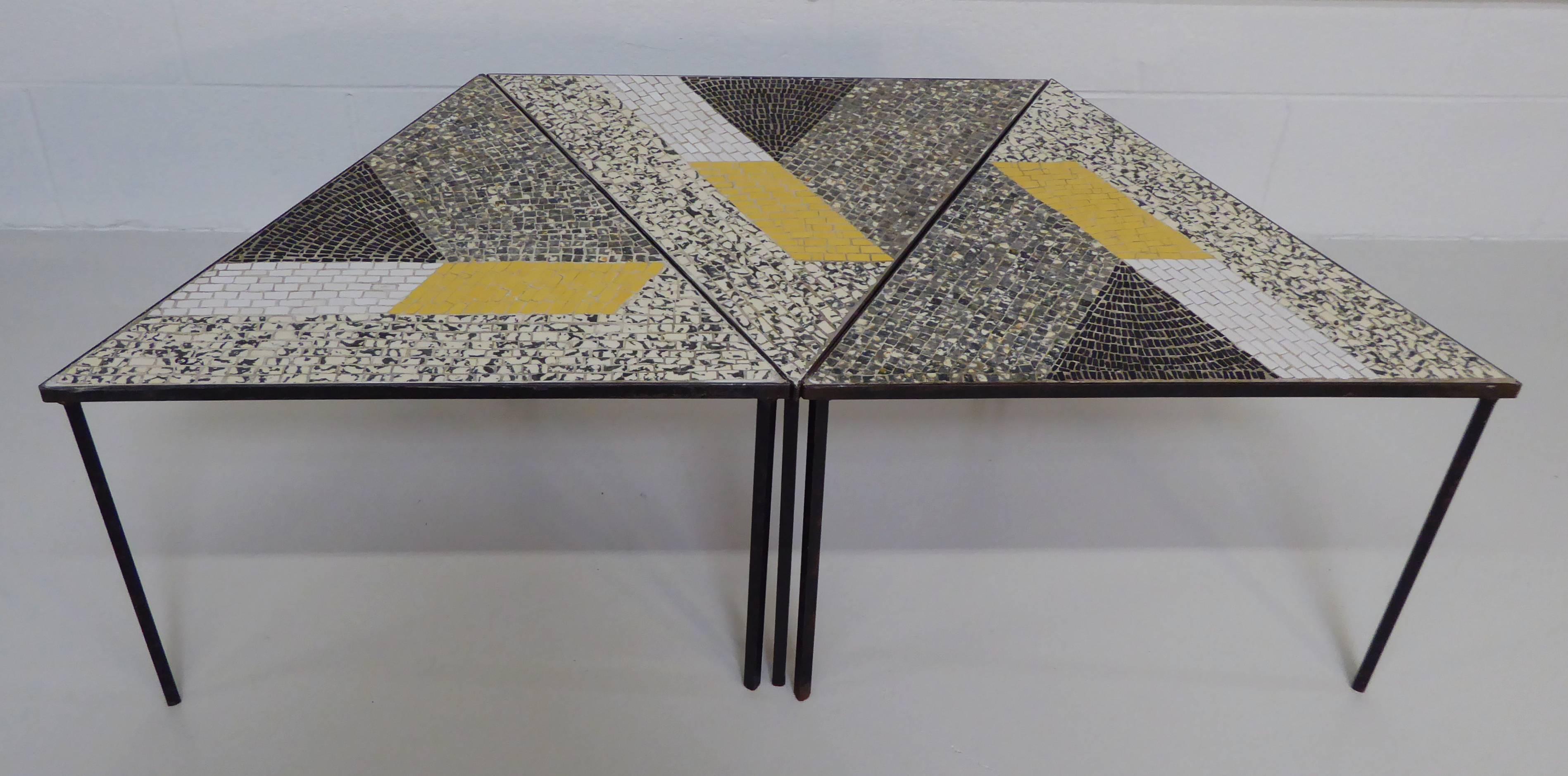 Exceptional handcrafted Mid-Century Modern Italian mosaic tile occasional tables. Set of three studio tile tables have iron bases with fire glazed tiles set in an abstract geometric pattern. Triangular shape allows for a Miriad of