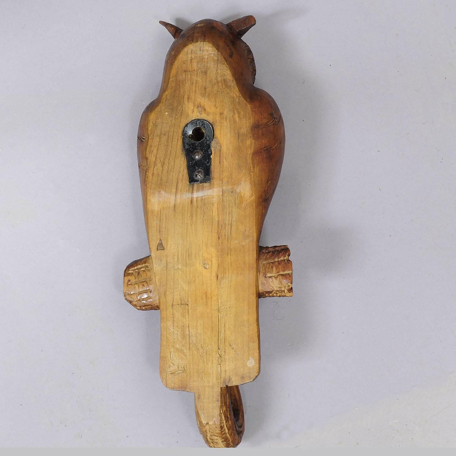 A nice hand-carved owl whip holder / coat hook. The owl is sitting on a branch which builds the coat hooks. Executed circa 1910. (Ears restored perfectly).