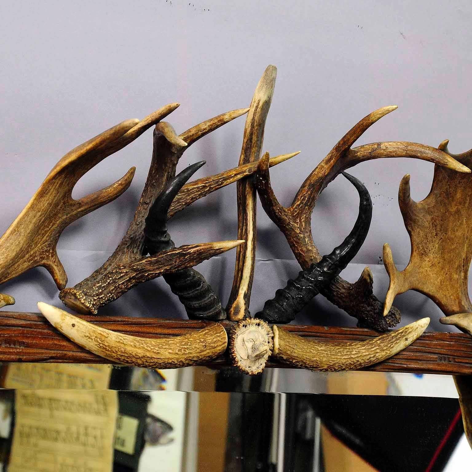 Carved Antique Antler Frame with Rustic Antler Decorations and Mirror