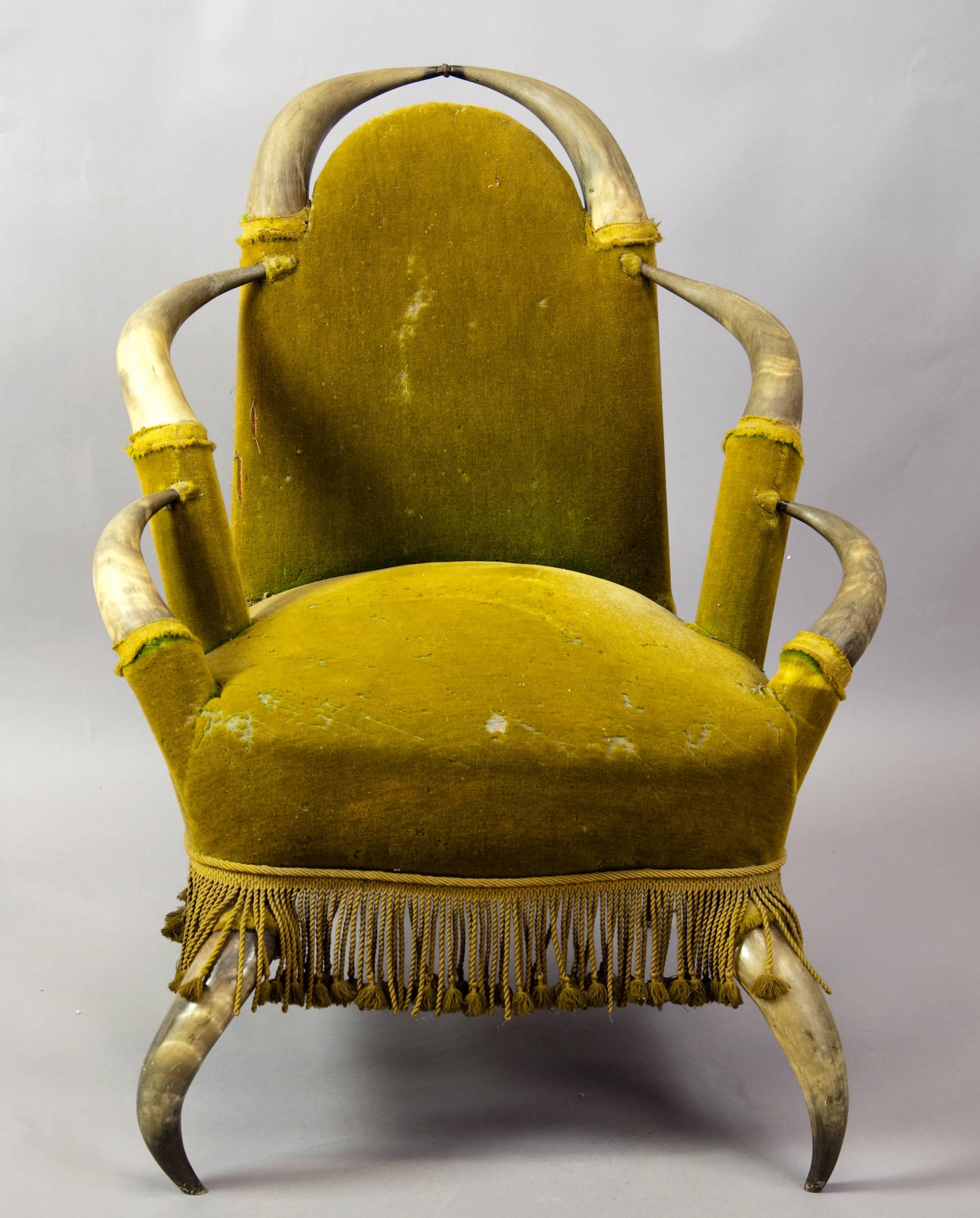 An antique bull horn chair, from a noble villa in Austria. With green velvet fabric.