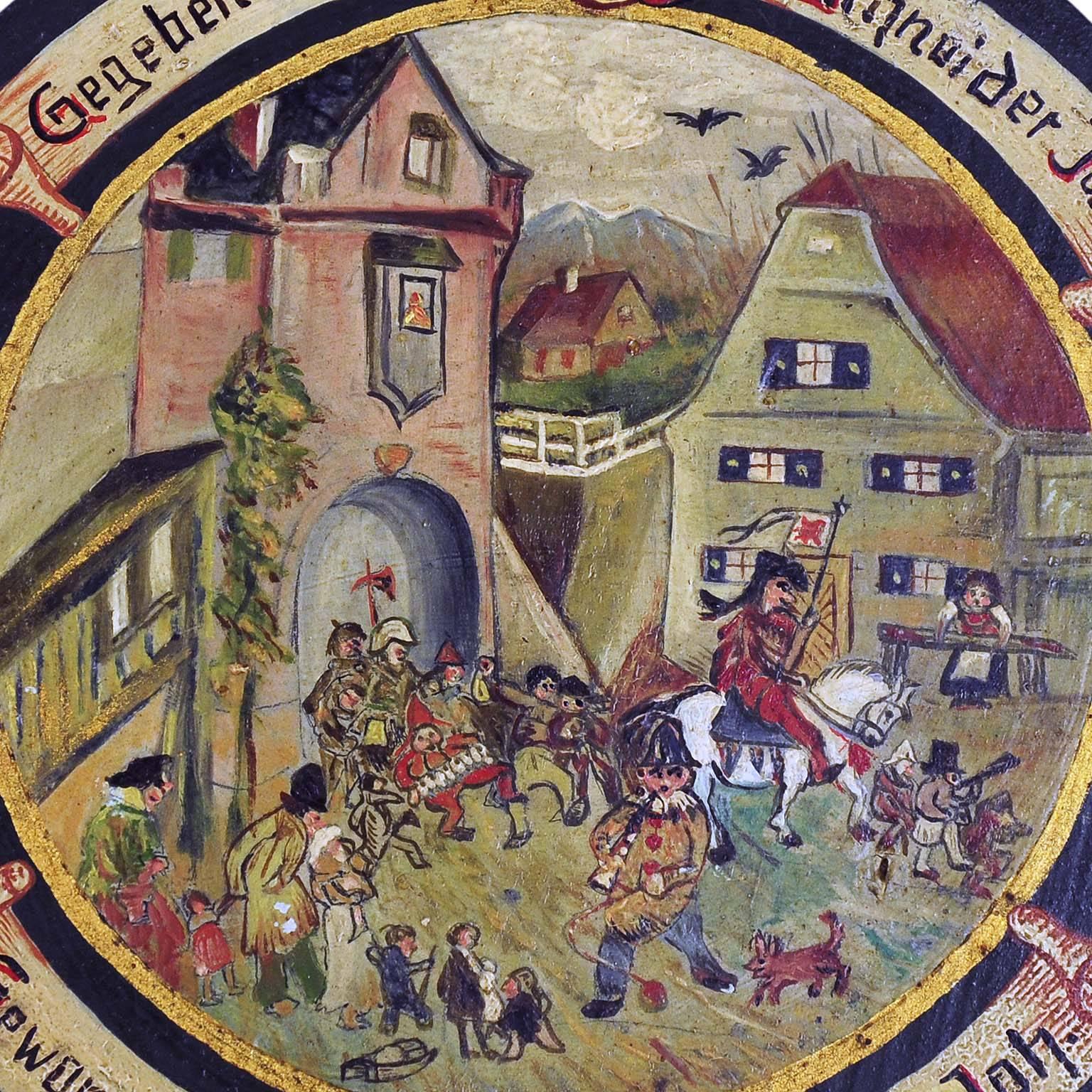 A rare hand-painted antique shooting target depicting a folksy village live scene. Oil on wood, hand-painted in naive painting style. Bavaria, circa 1920. On the base with impacts of the shooting. On the back handwritten list of the participants of