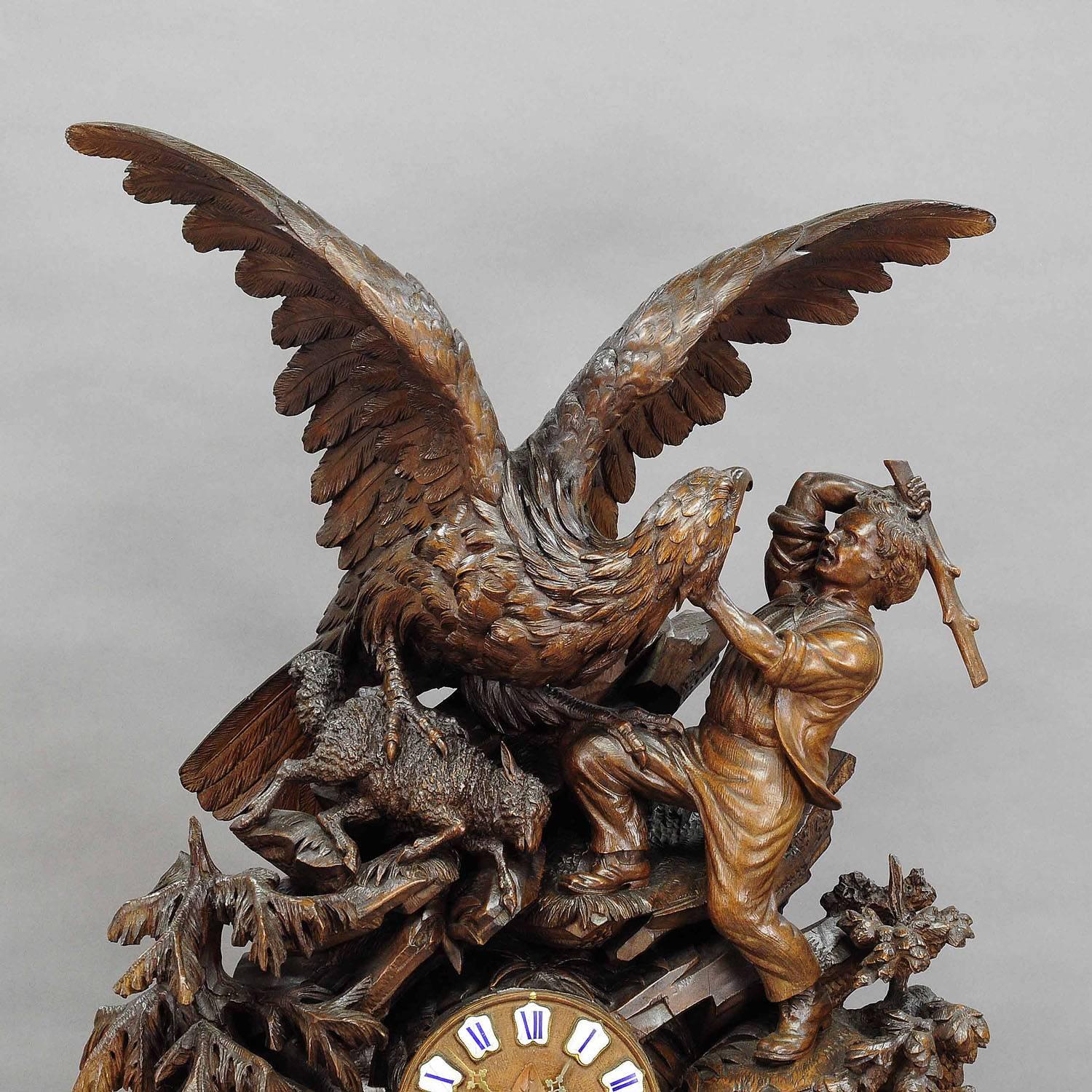 A world class wooden black forest mantel clock. Decorated with a finely carved eagle attacking a mountain sheep. The shepherd is defending the sheep. An extremely rare and elaborate carved clock. Executed in Brienz, circa 1900, the clockwork is