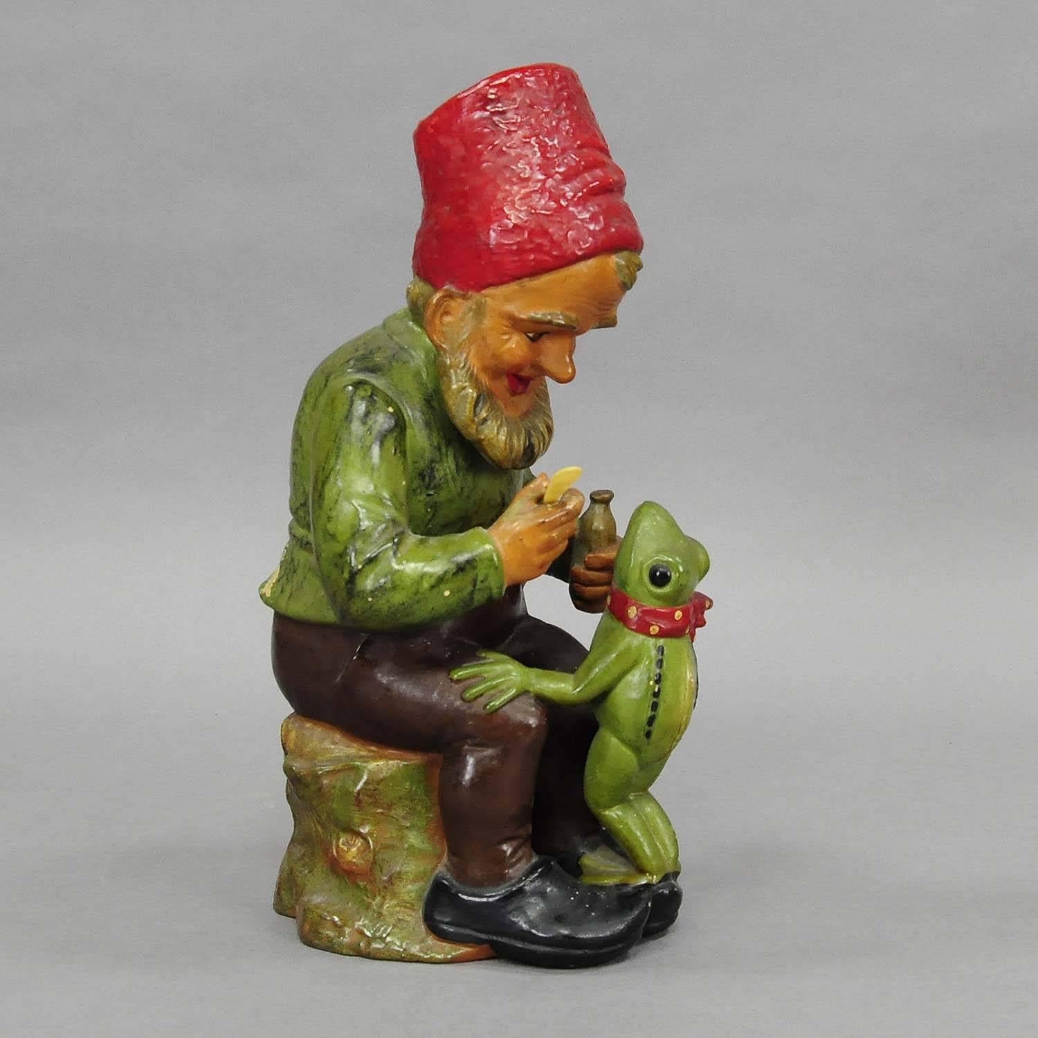 A great and rare sculpture of a dwarf delivering medicine to a frog which has a cold. made of terracotta, with original painting, most probably manufactured by Heissner, Germany, circa 1930.