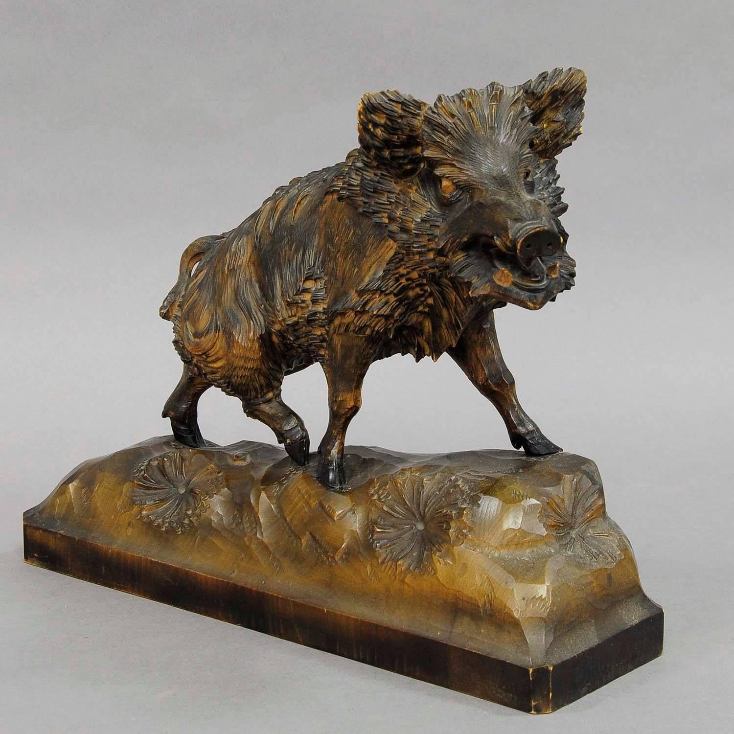 A hand-carved wood sculpture of a wild boar. Very detailed natural carving. Black Forest, circa 1950.