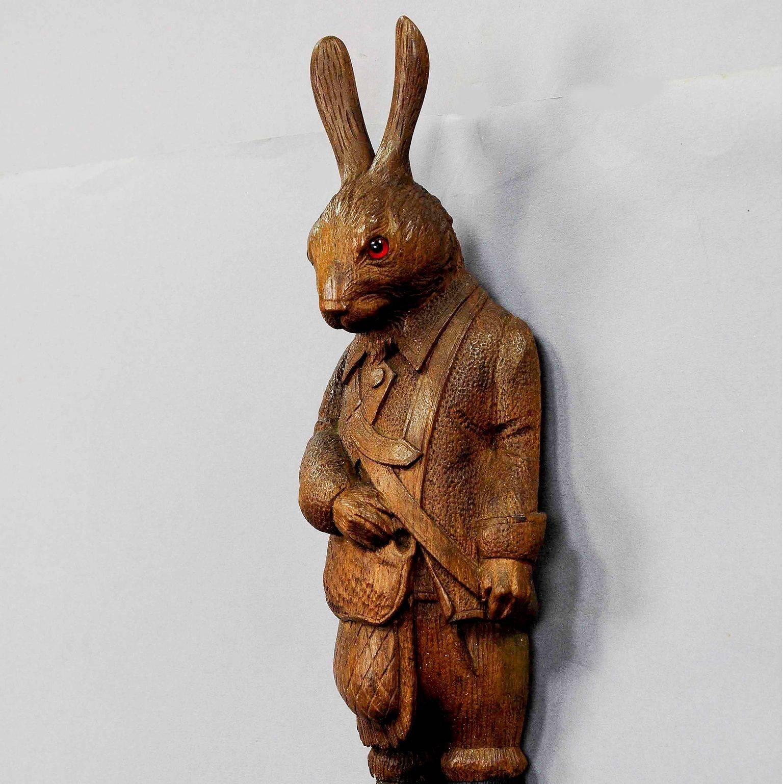 a whimsical handcarved hunting hare whip holder / coat hook. executed ca. 1900, swiss - brienz.