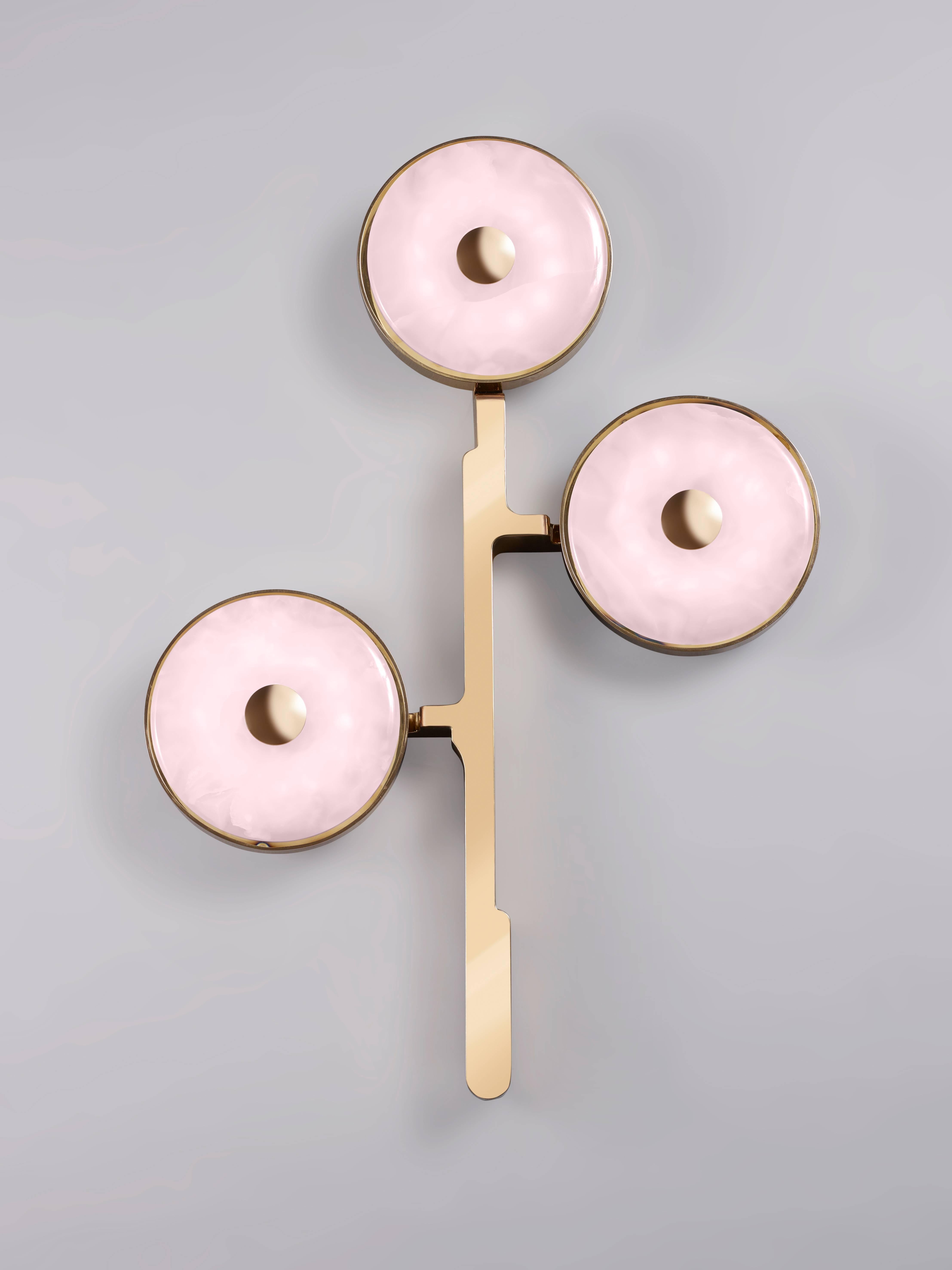 The 'JinShi Pink Jade' glamorous sconce by acclaimed design duo Studio MVW is a true jewel for the home. Pricing is for a set of two. Each sconce encompasses three retro-lit heads in natural pink jade, an exceptional gemstone with a sumptuous powder