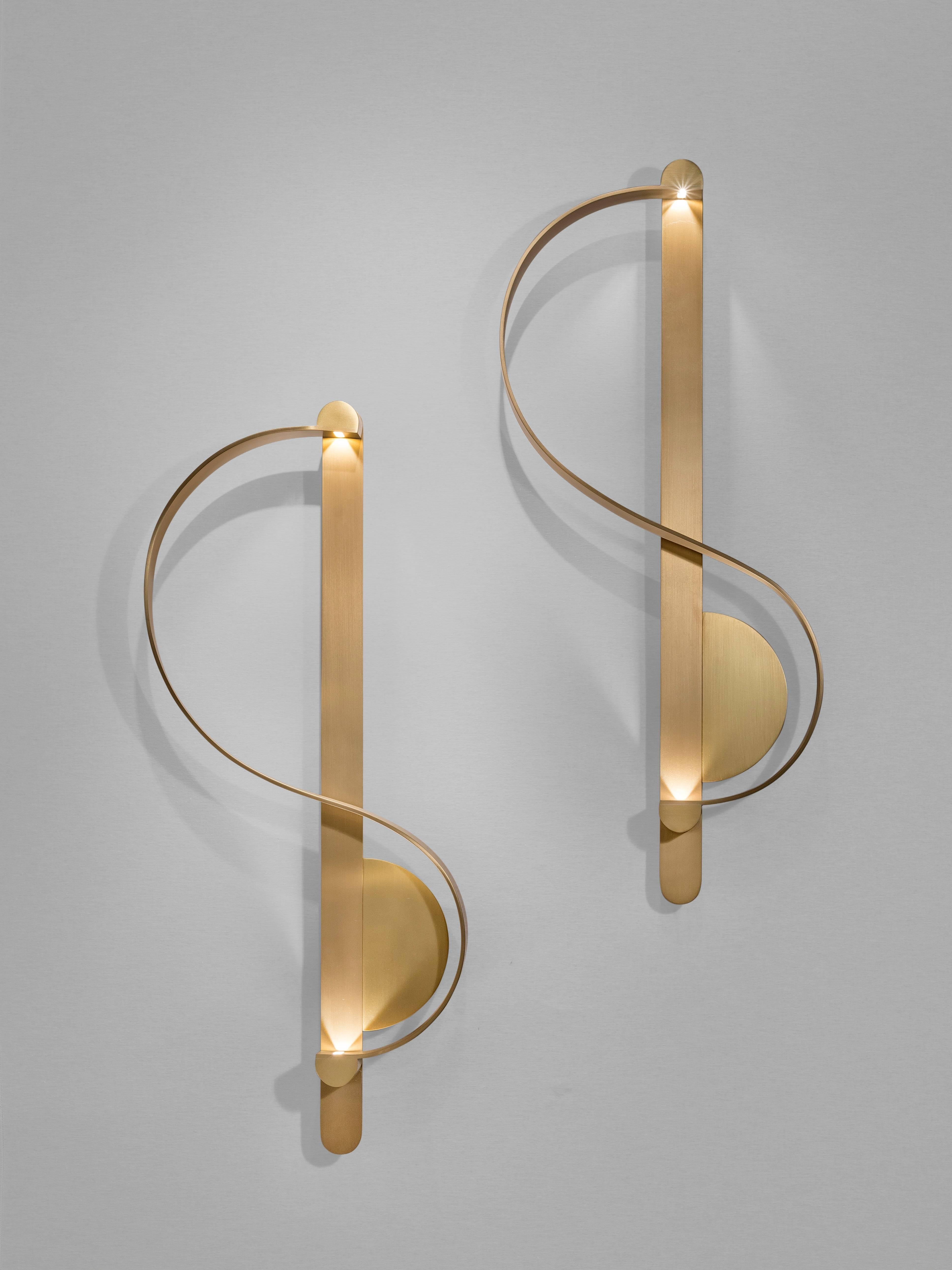 This pair of 'Clé De Sol' sculptural sconces by French-Lebanese Charles Kalpakian is produced entirely in gilded brushed brass. The design is inspired by the calligraphy of sheet music. In this wall light, the classic G Clef shape is transformed