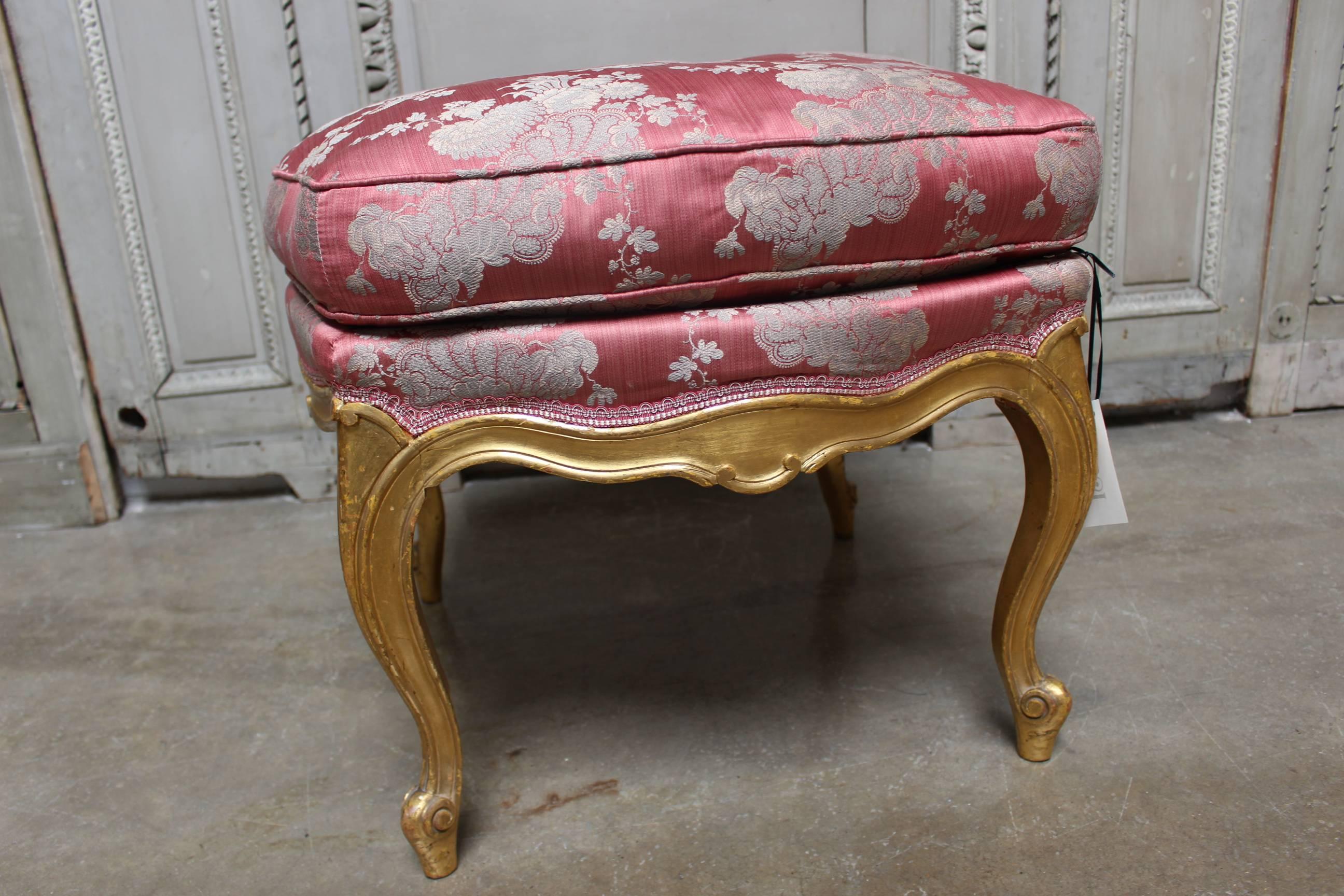 A French Louis XV style tabouret with a gold leaf finish.