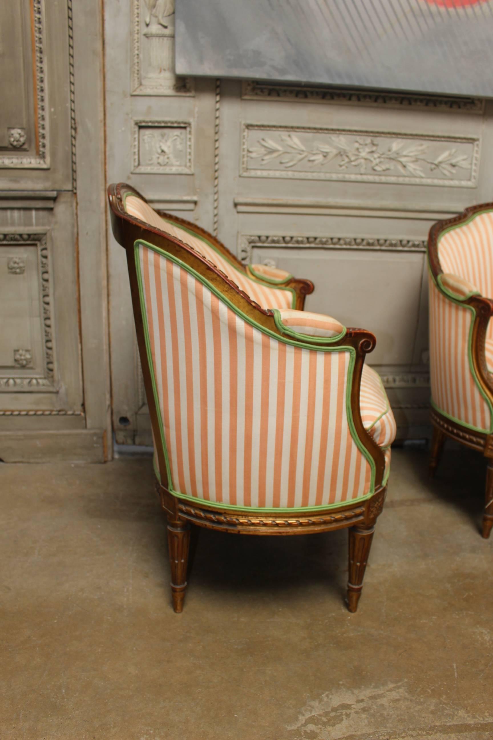 Carved Pair of 19th Century French Louis XVI Style Armchairs with a Gold Leaf Finish For Sale
