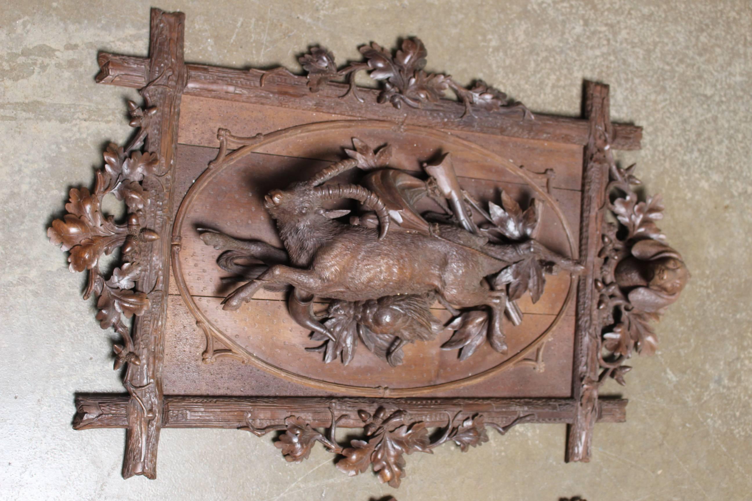 French pair of 19th century carved wood hunting panels in the style of Black Forest. These are beautifully carved with both panels depicting animals, hunting hounds foliage and acorns.