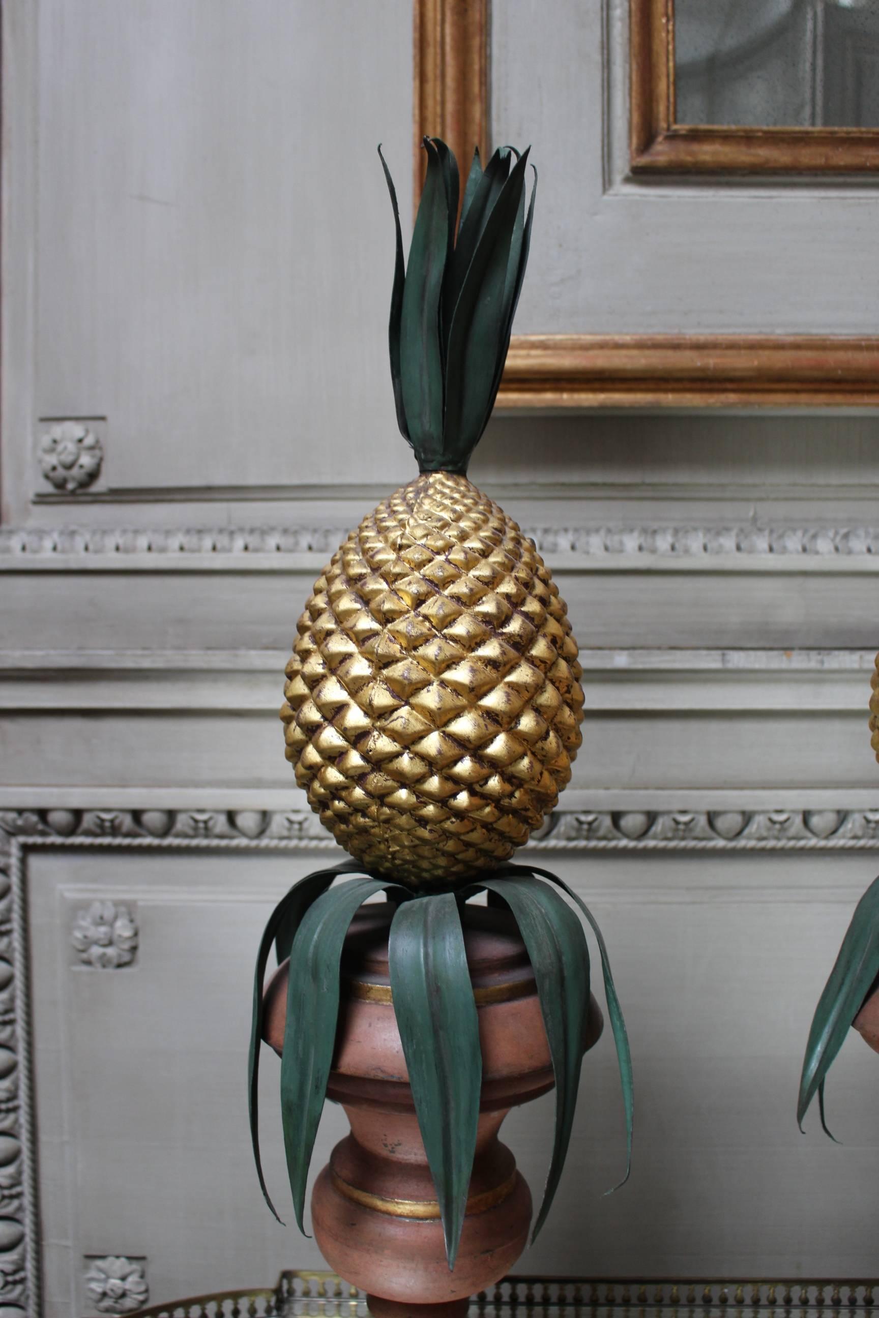 Pair of Italian painted and gilded tole urns with pineapples created for Maison Jansen.