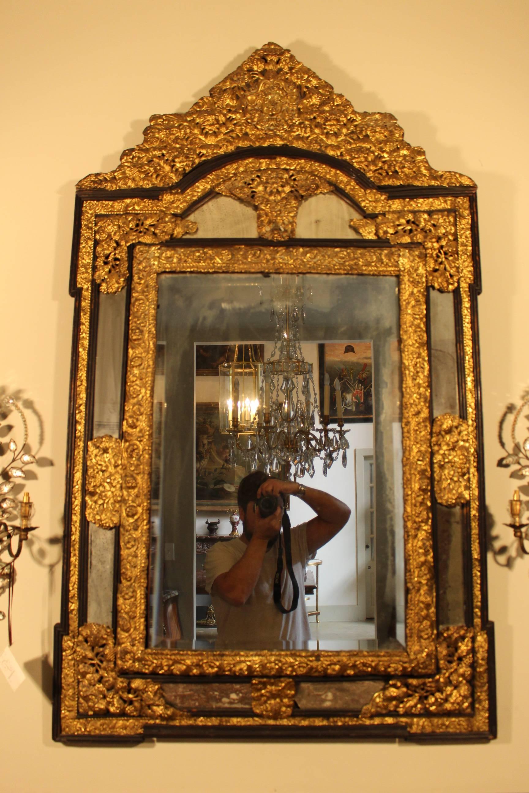 A French Regence style repoussee mirror, mid-19th century.